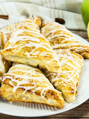 Apple Turnovers with glaze drizzled on top.