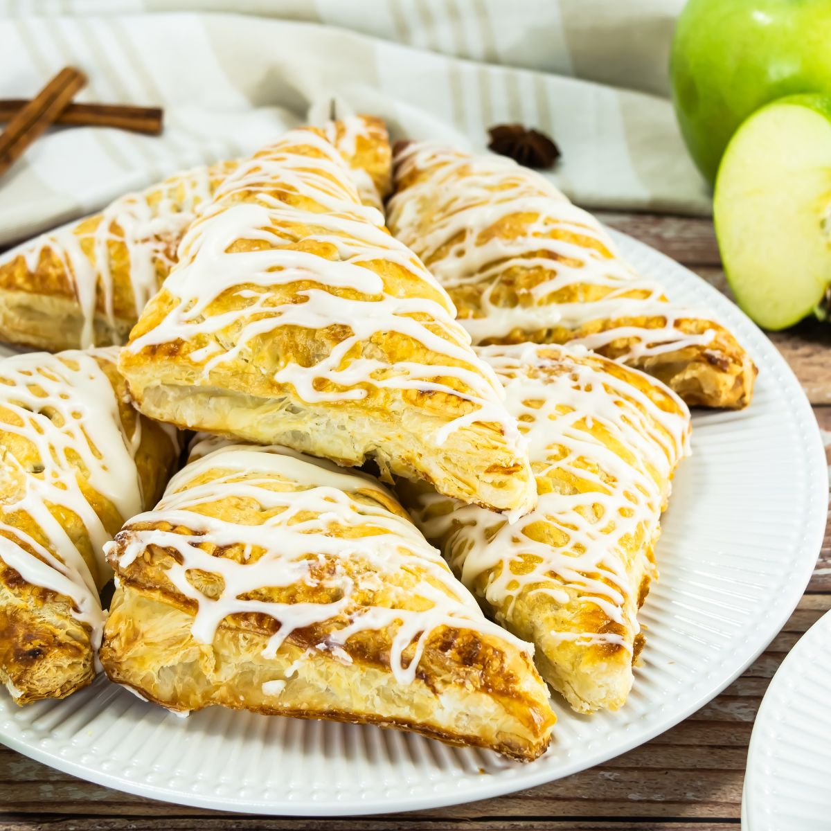 Apple Turnovers with glaze drizzled on top.
