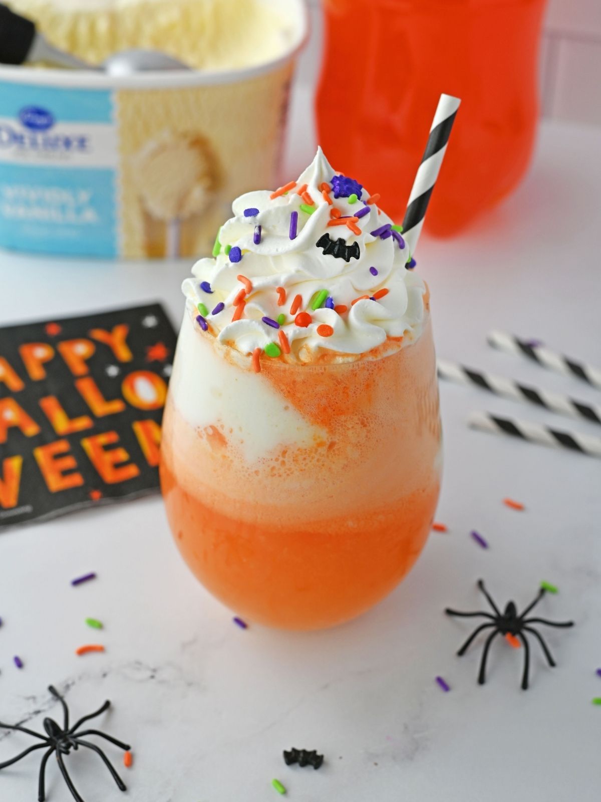 Orange soda ice cream float with whipped cream and sprinkles.