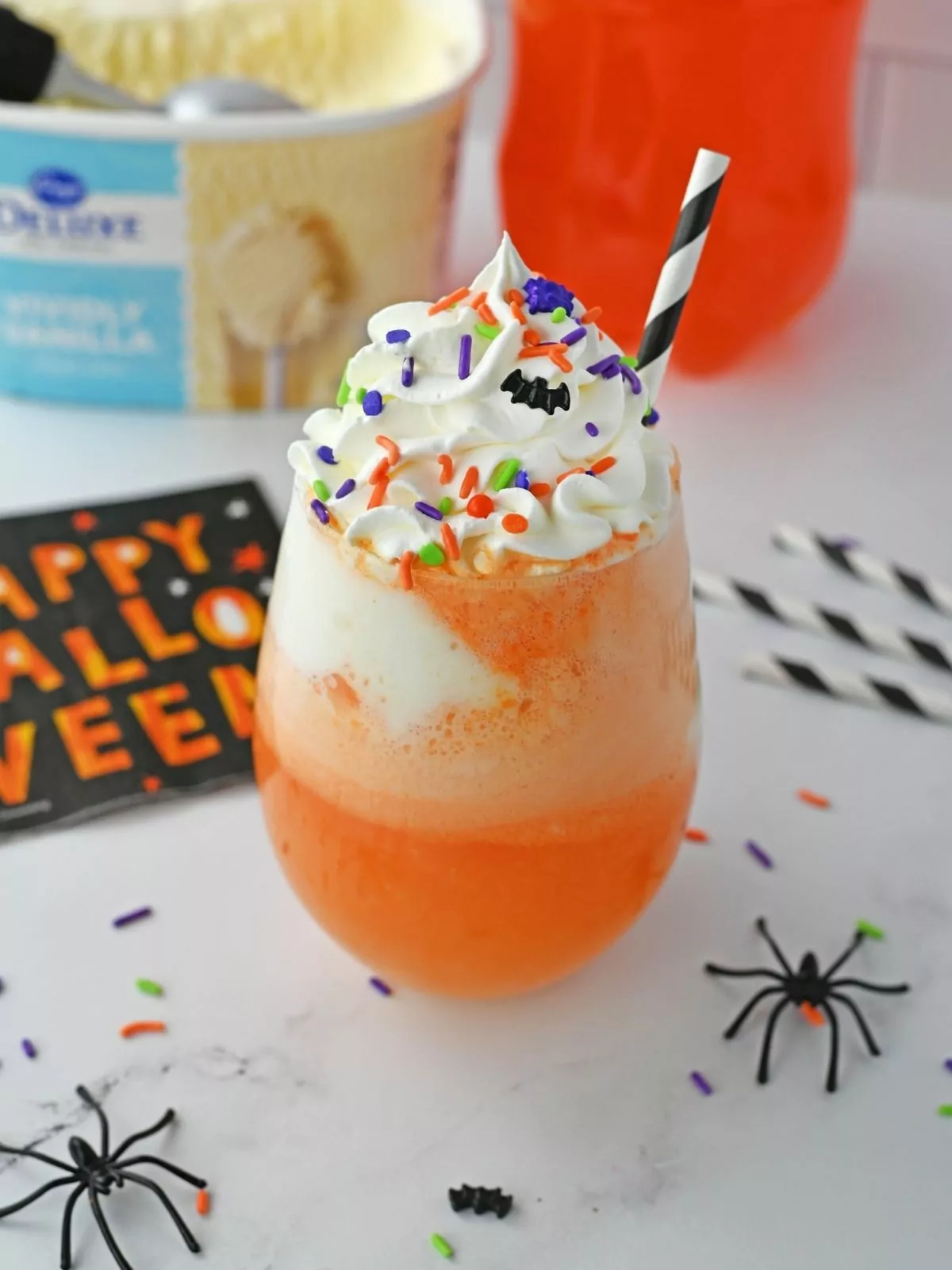 Orange soda ice cream float with whipped cream and sprinkles.