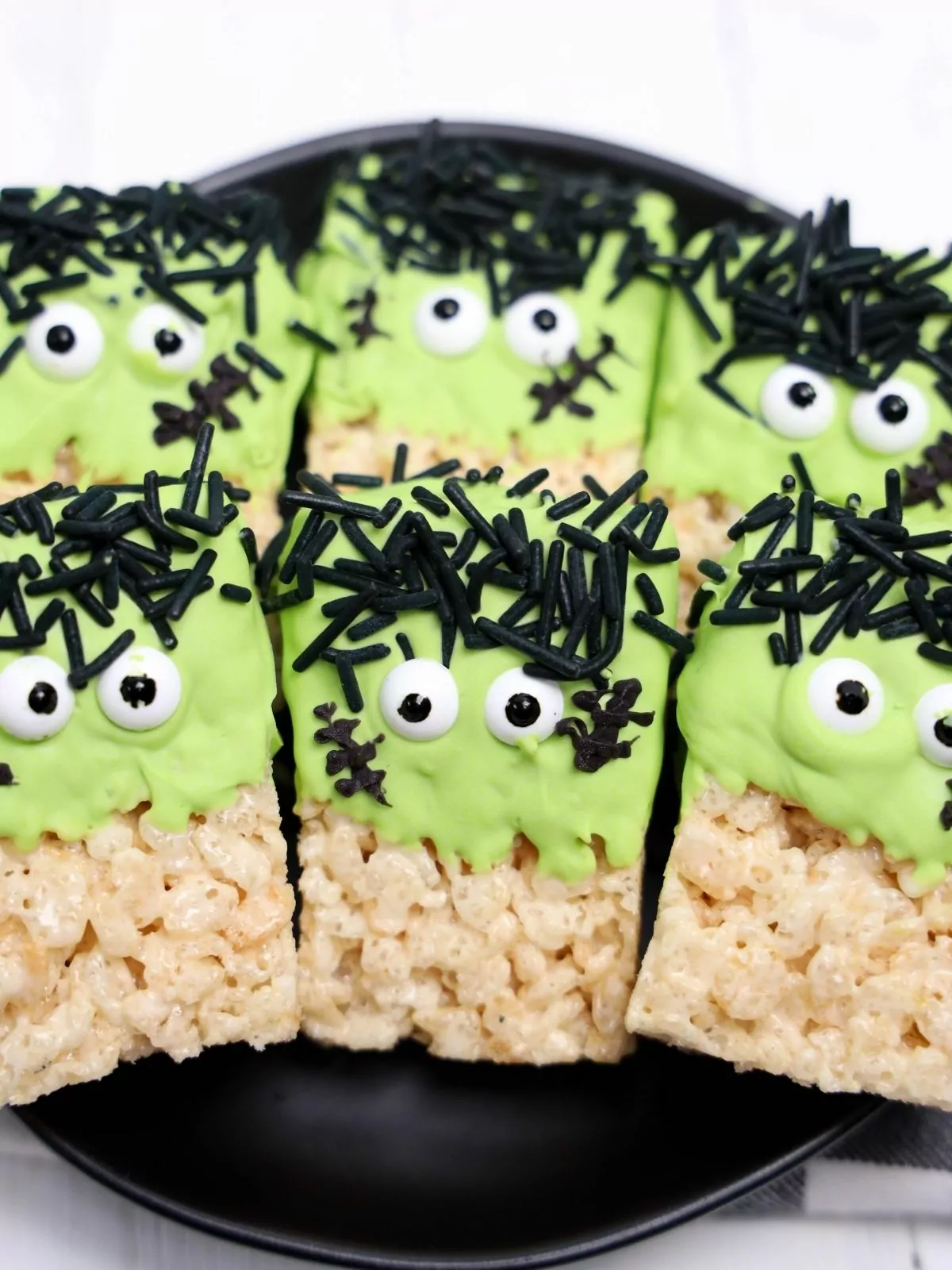 Frankenstein Rice Krispie Treats on a black plate.