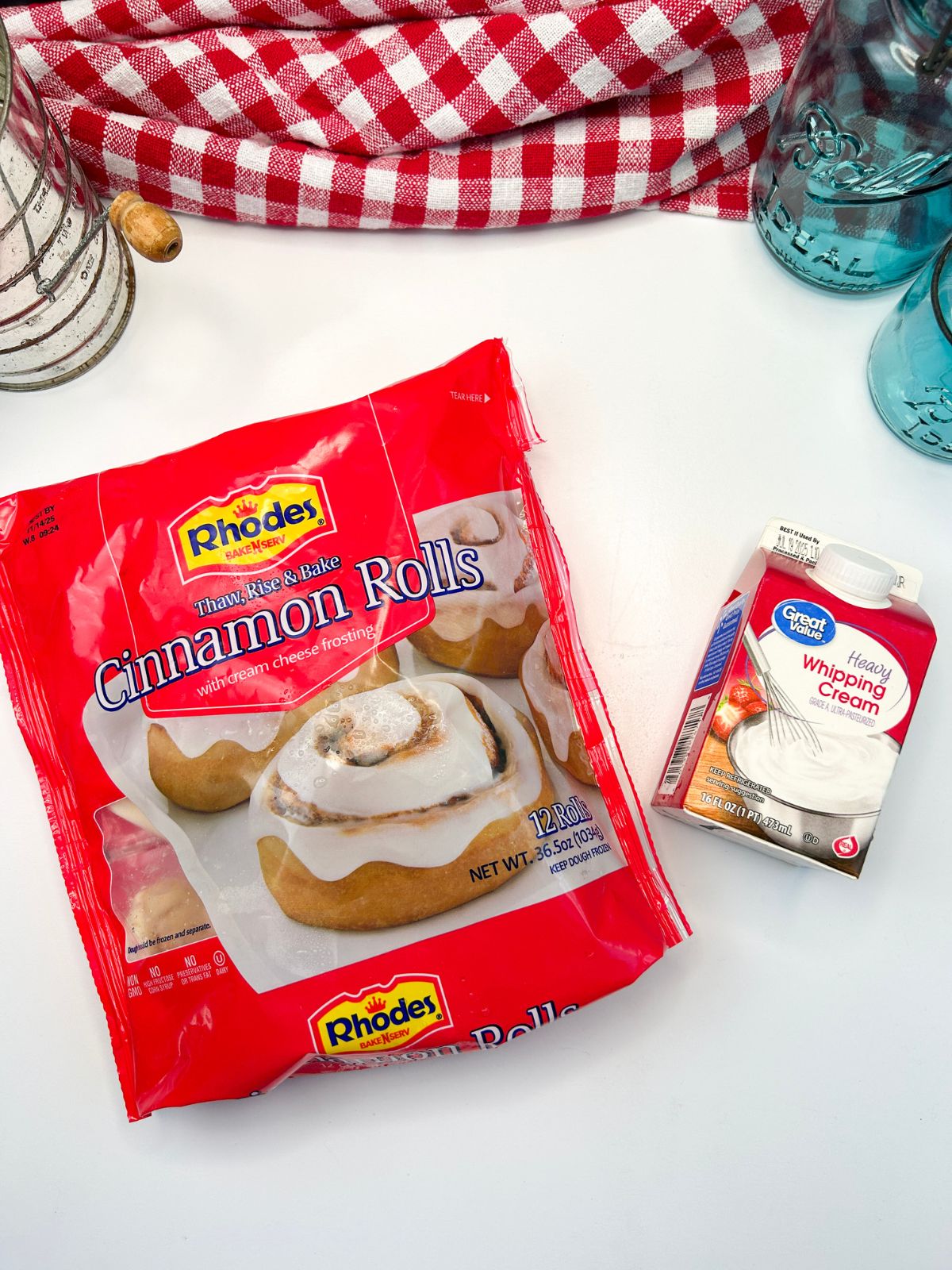 Bag of Rhodes Cinnamon Rolls and a carton of heavy whipping cream.