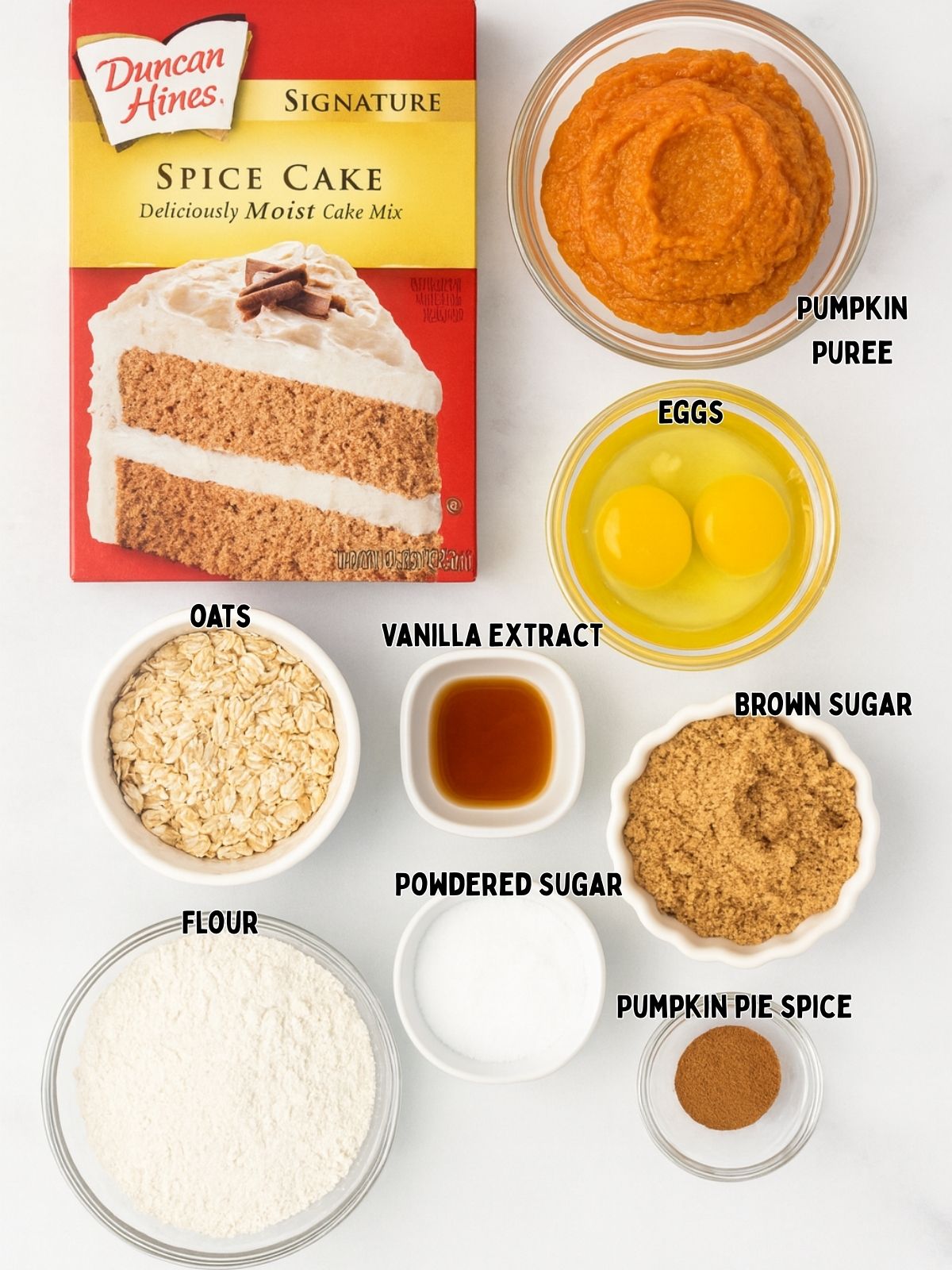 Flat lay photo of pumpkin glazed donuts ingredients including spice cake mix, pumpkin puree, eggs, butter, brown sugar, flour, oats, pumpkin spice, powdered sugar, and vanilla in clear bowls.