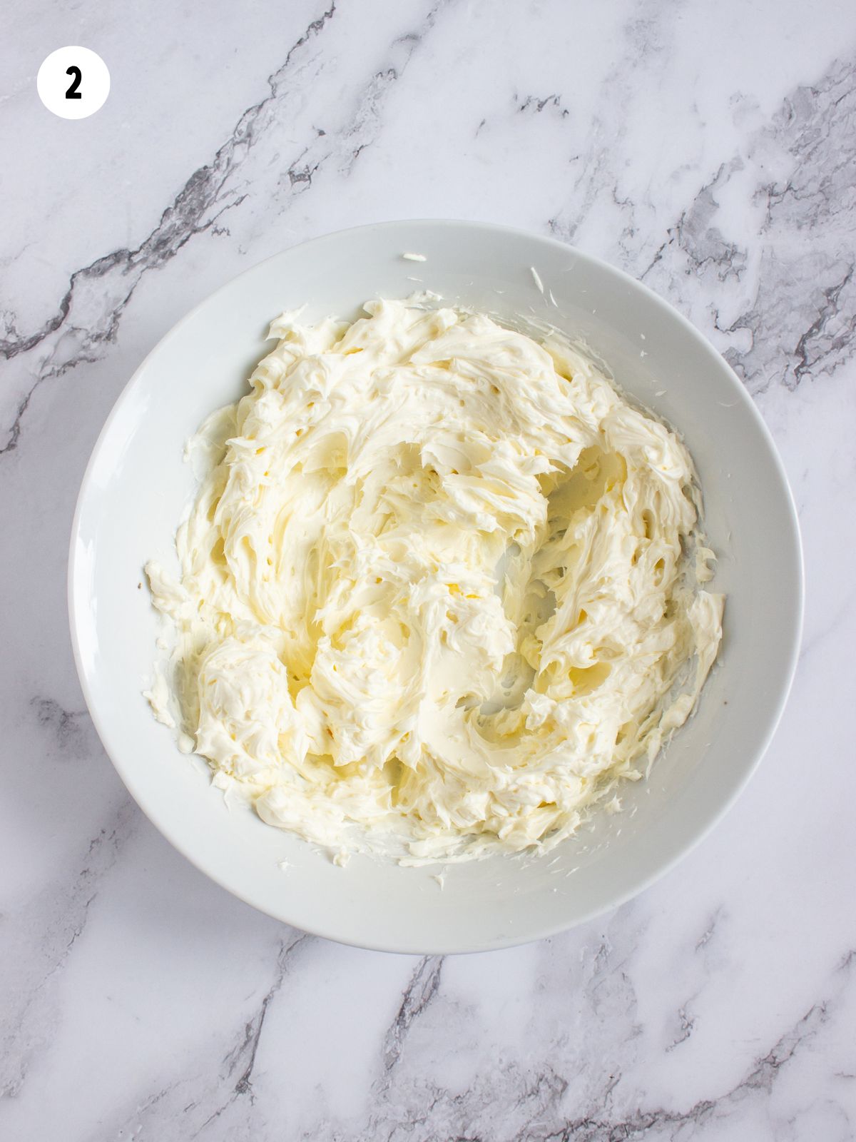 Cheesecake mixture in white bowl.