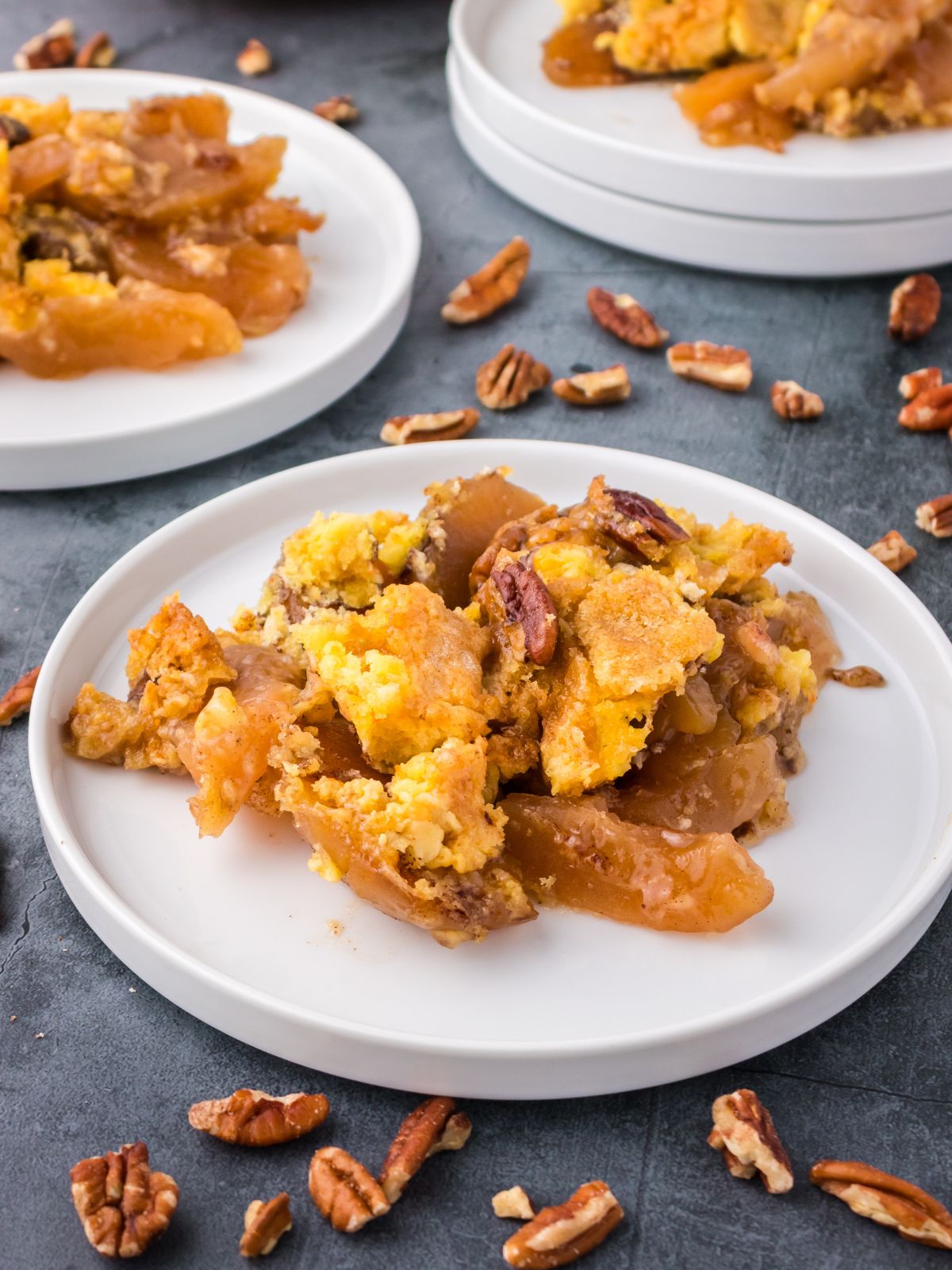 White plates filled with apple dump cake.