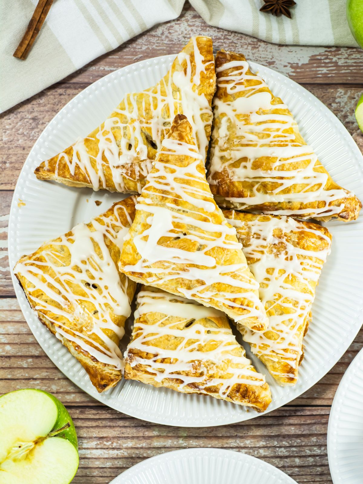 Overhead view of a plate of apple turnovers.