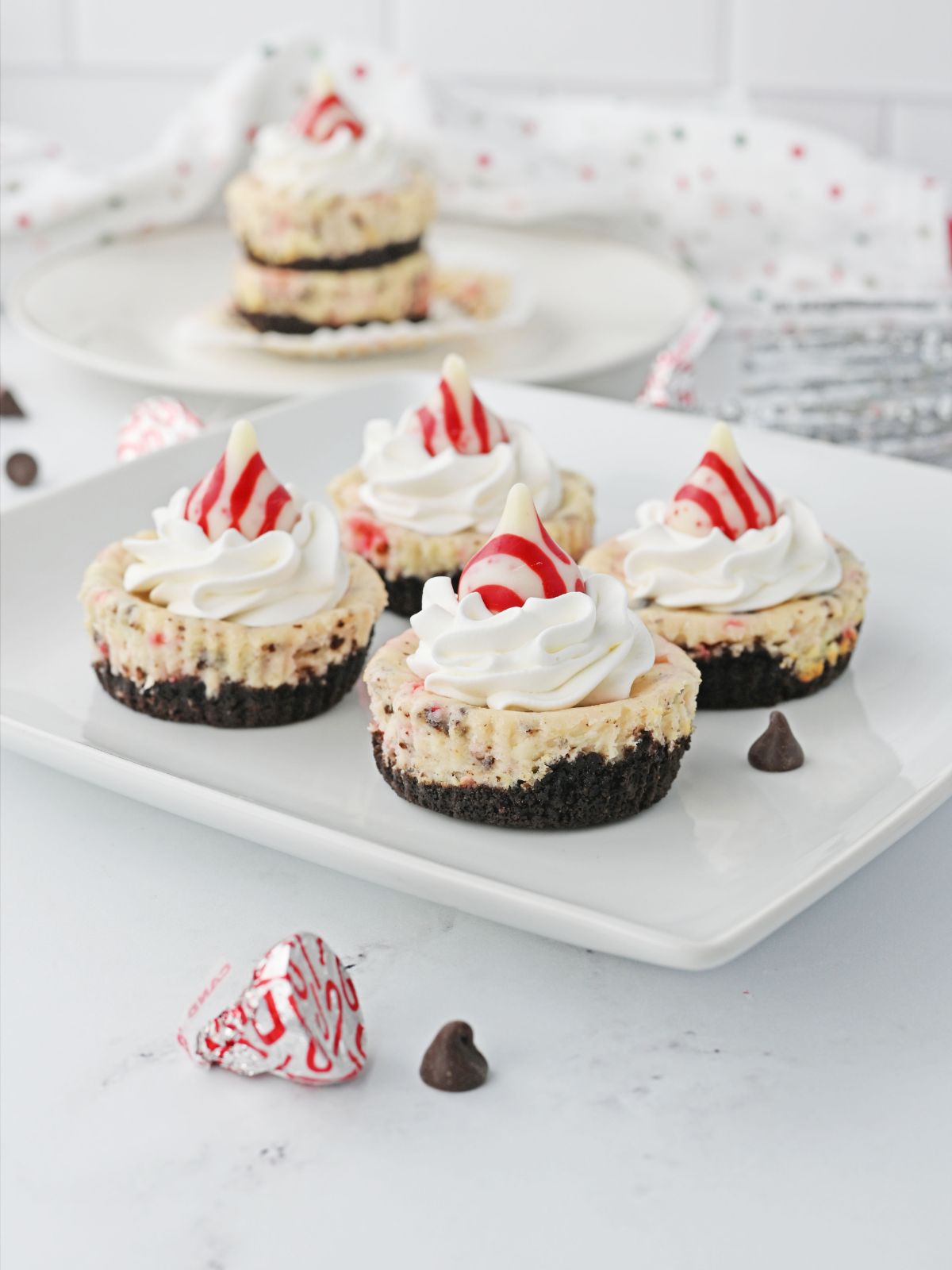 Christmas Mini Cheesecakes topped with peppermint Hershey Kisses.