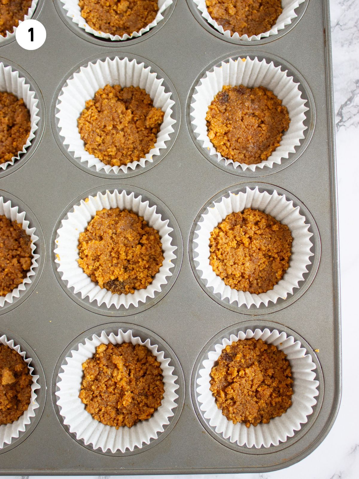 graham cracker crust in muffin pans.
