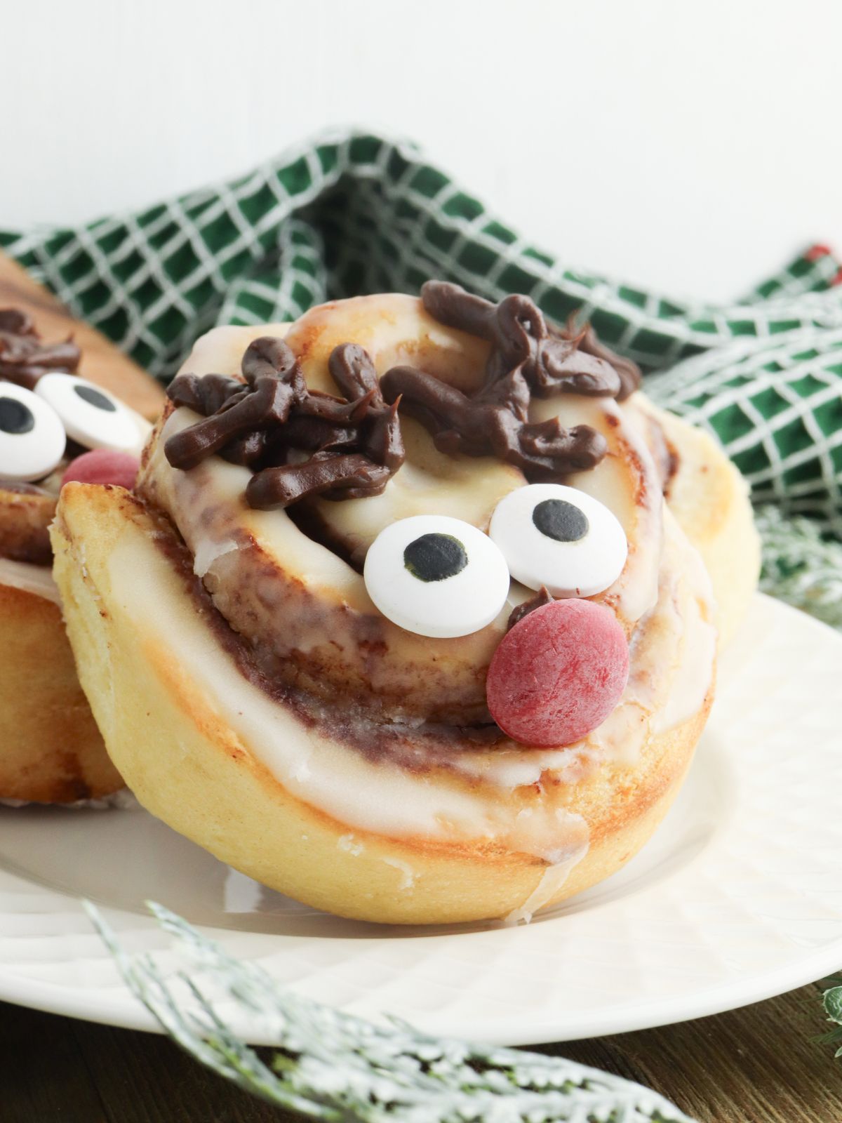 Cinnamon roll decorated like Rudolph the Red Nose Reindeer.