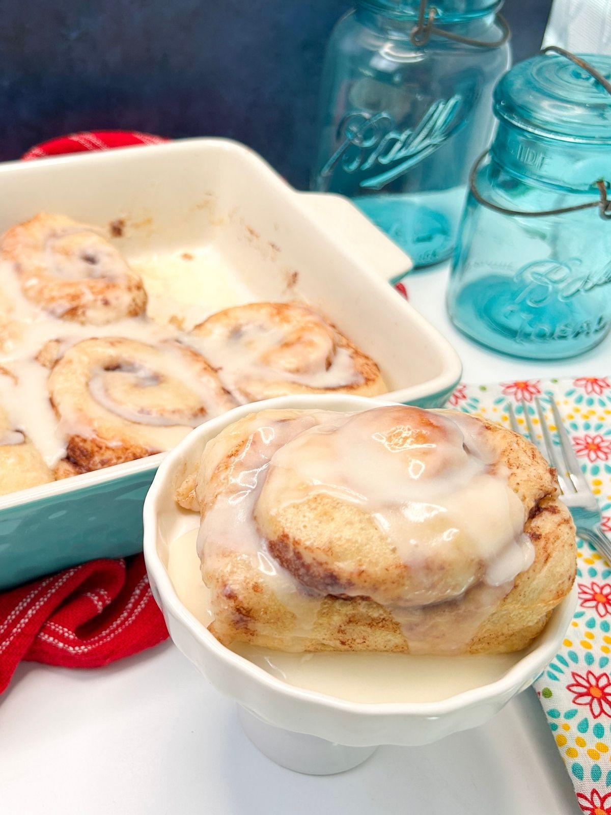 Cinnamon roll served on white dish.