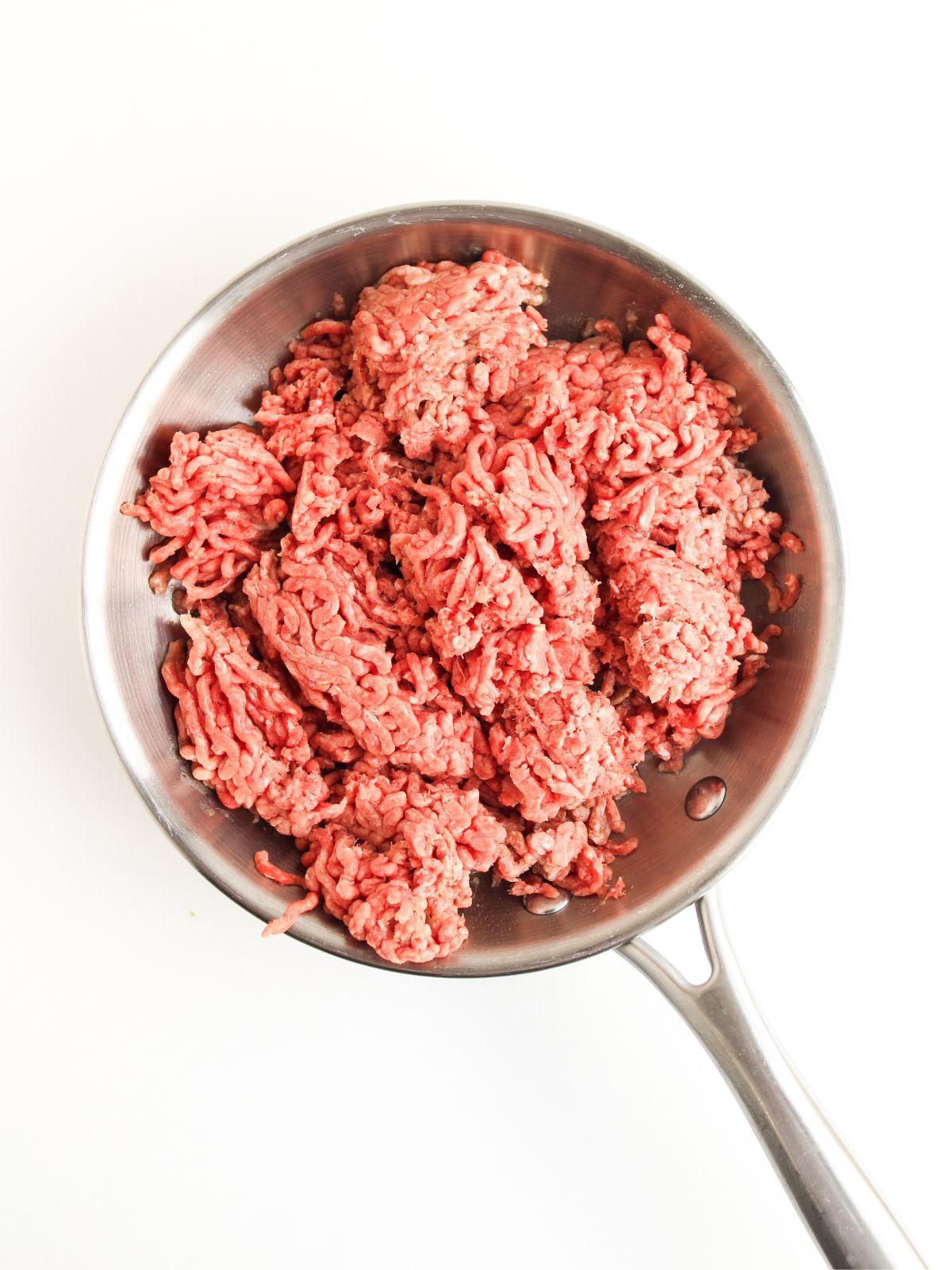 raw ground beef in skillet.