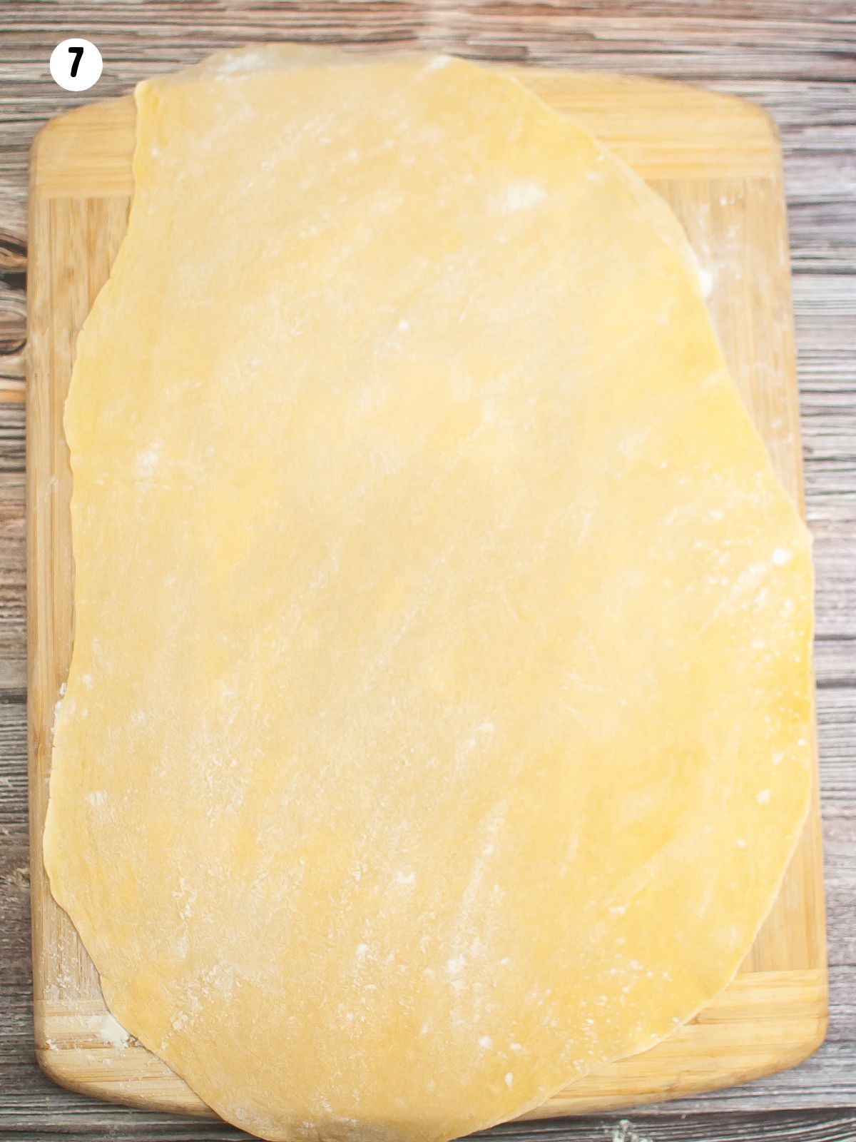 rolled out pasta dough on floured cutting board.