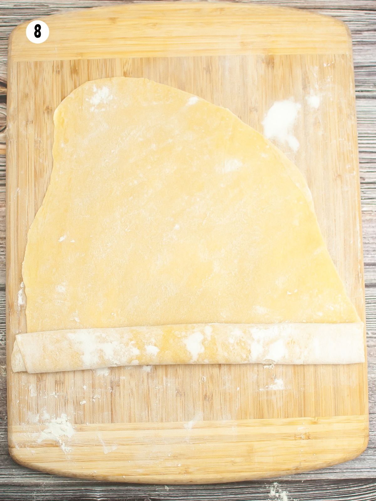 roll up pasta dough into a long cylinder.
