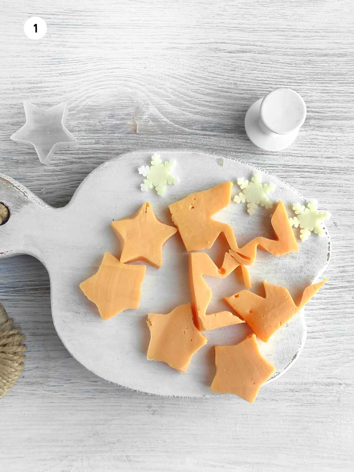 cut out shapes in cheeses using cookie cutters.