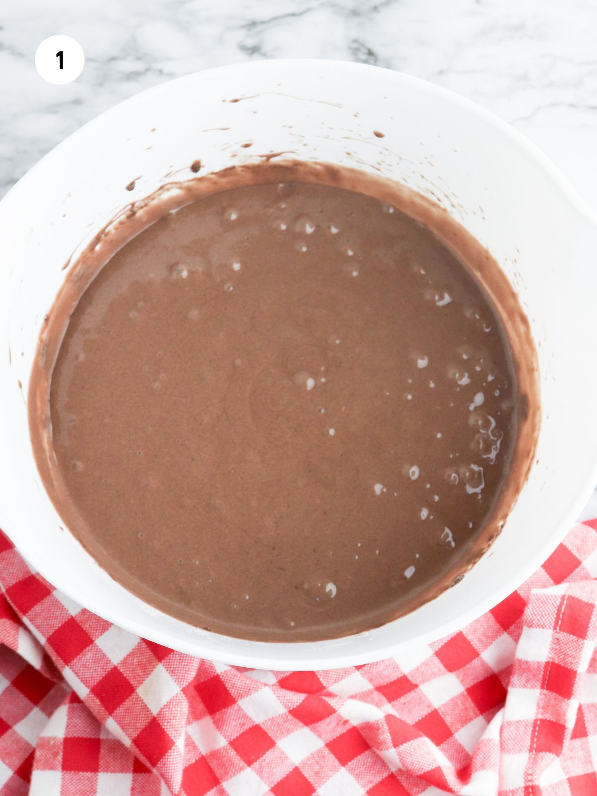 Cake batter in a white mixing bowl.