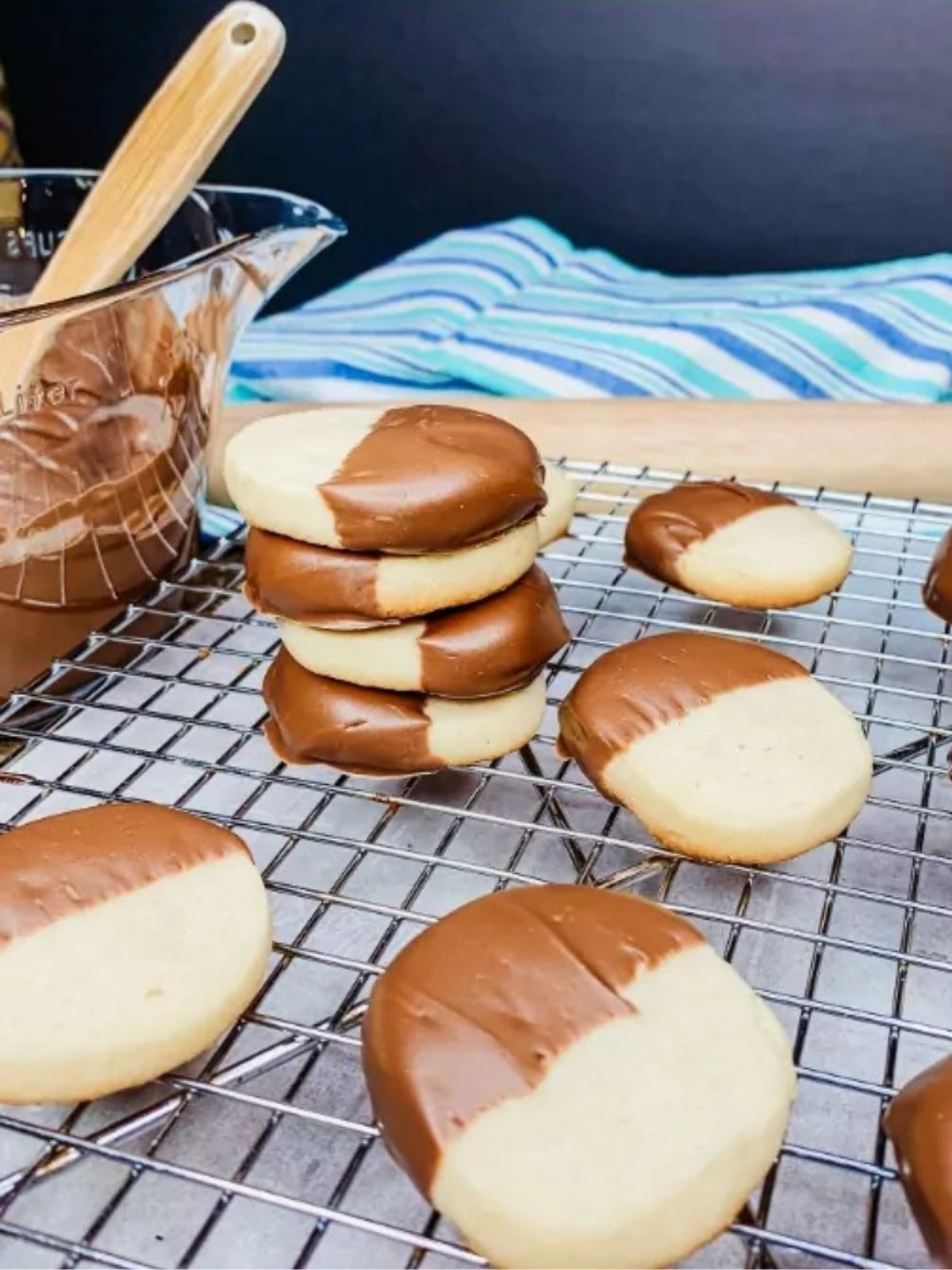 chocolate dipped slice and bake cookies on cooling rack and a few cookies stacked.