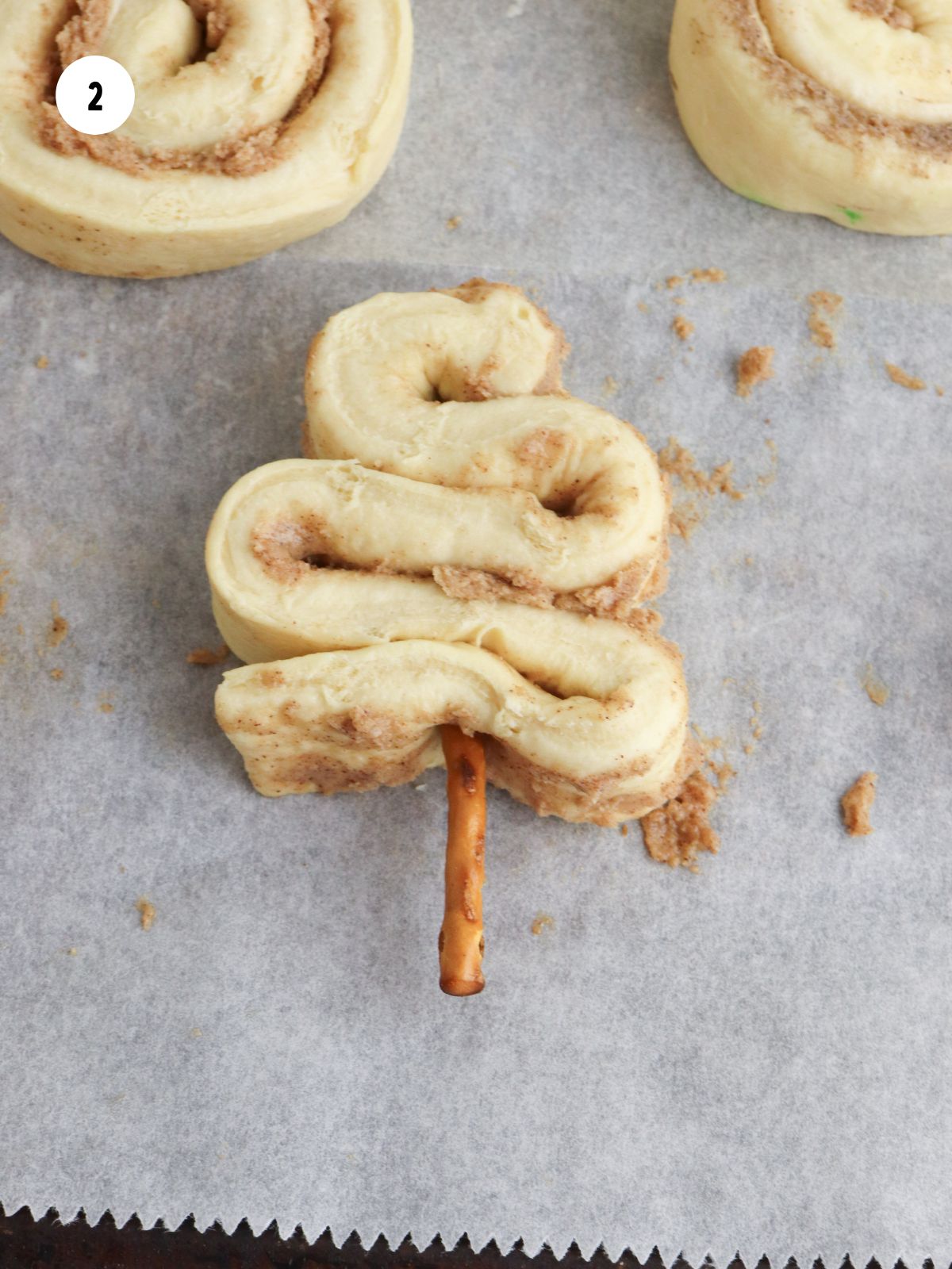 Pretzel stick added to the bottom of the tree shaped dough.