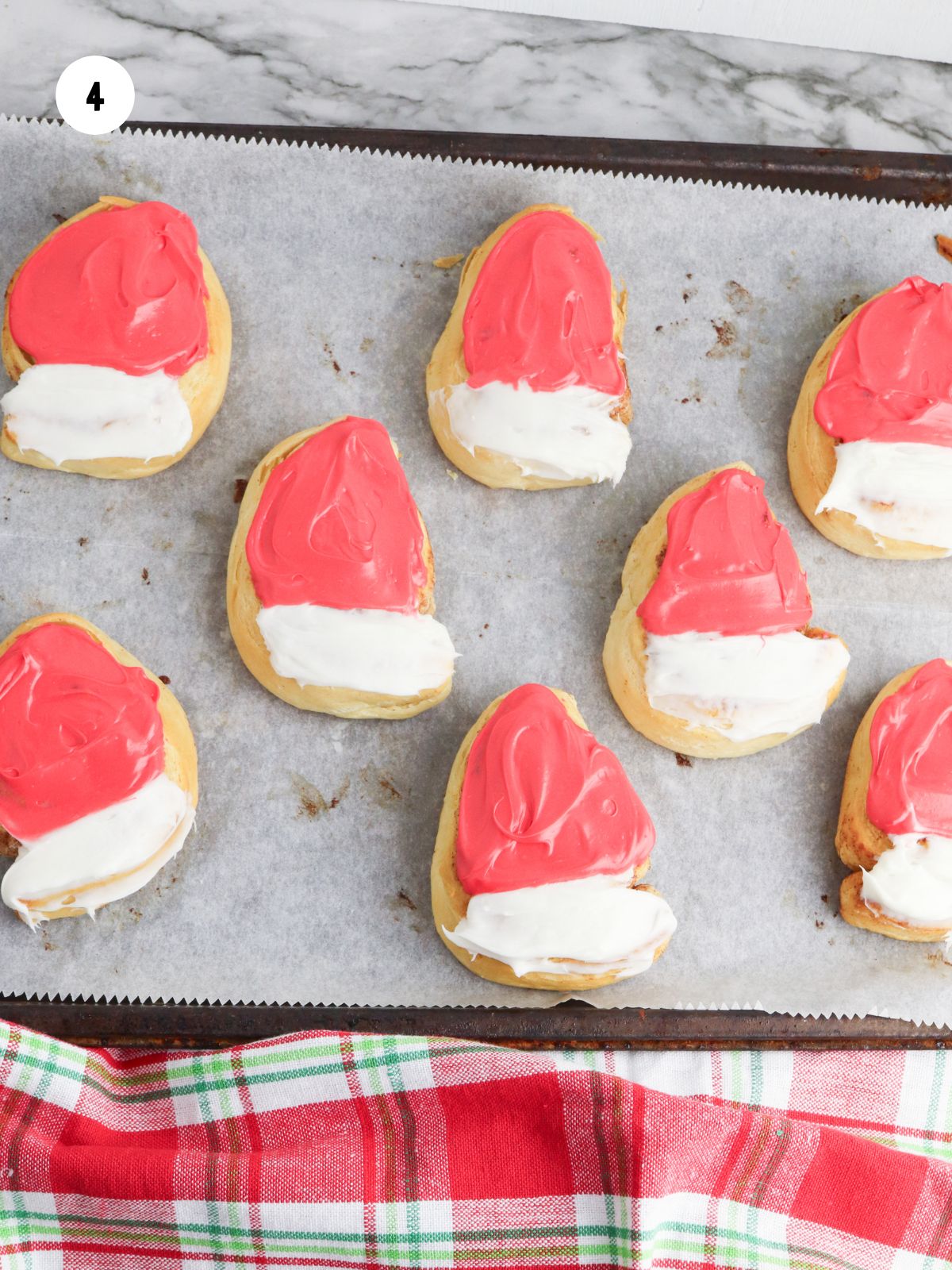The rest of the cinnamon roll frosted with red frosting.