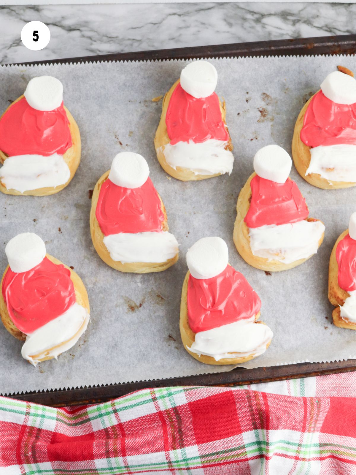 Large marshmallows cut in half and place on the tops of each triangle cinnamon roll.