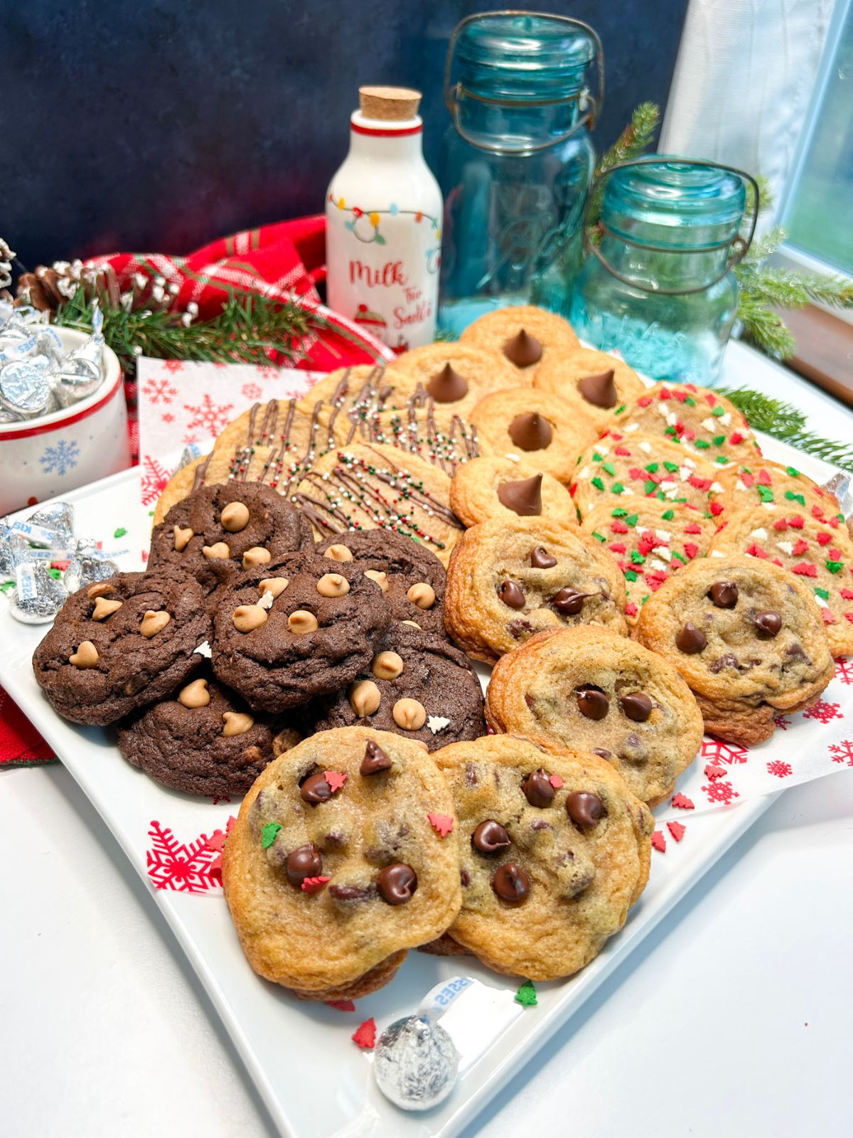 5 different cookies on a white platter for Christmas.
