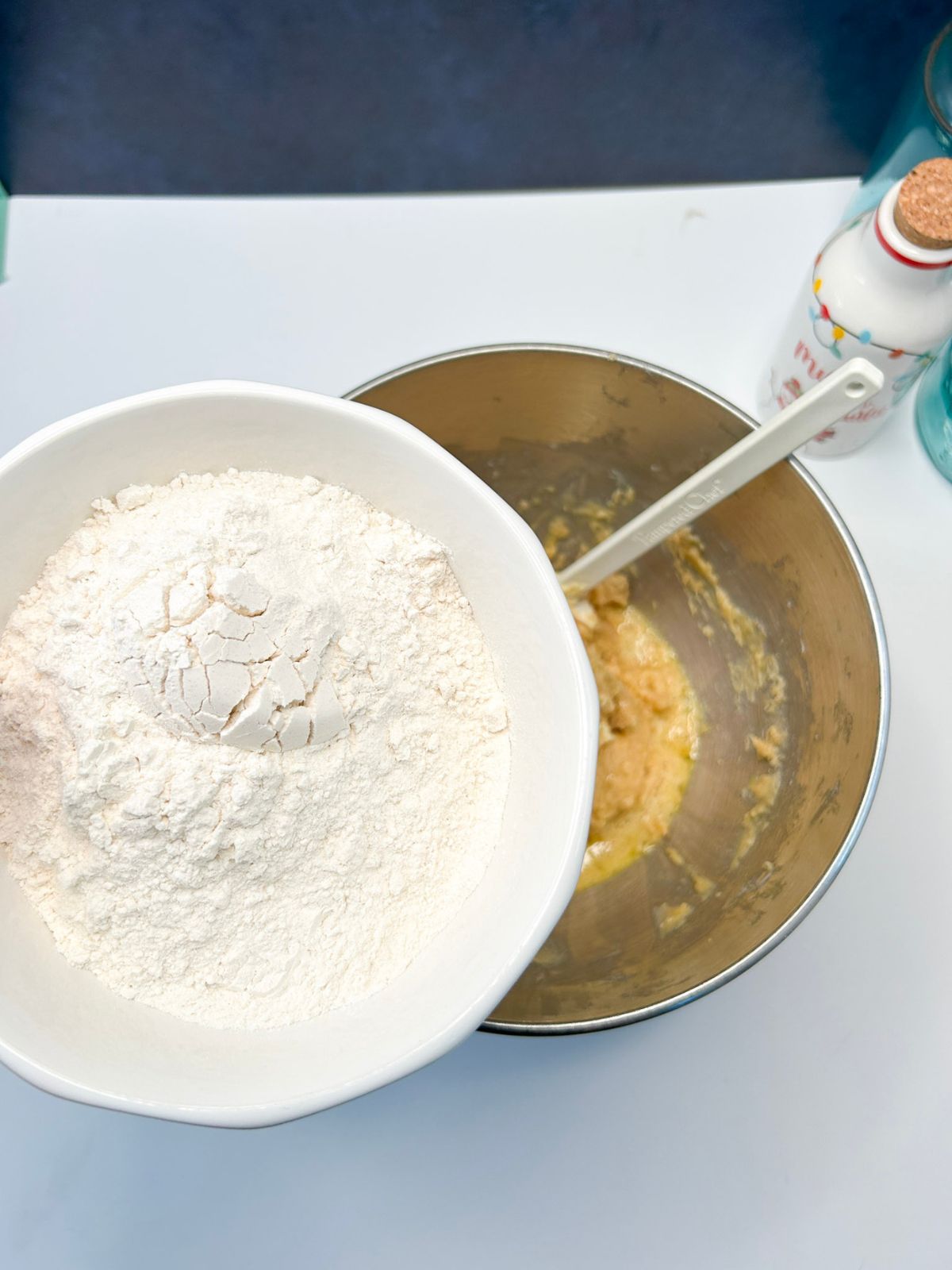 adding flour to bowl of creamed butter and sugar.