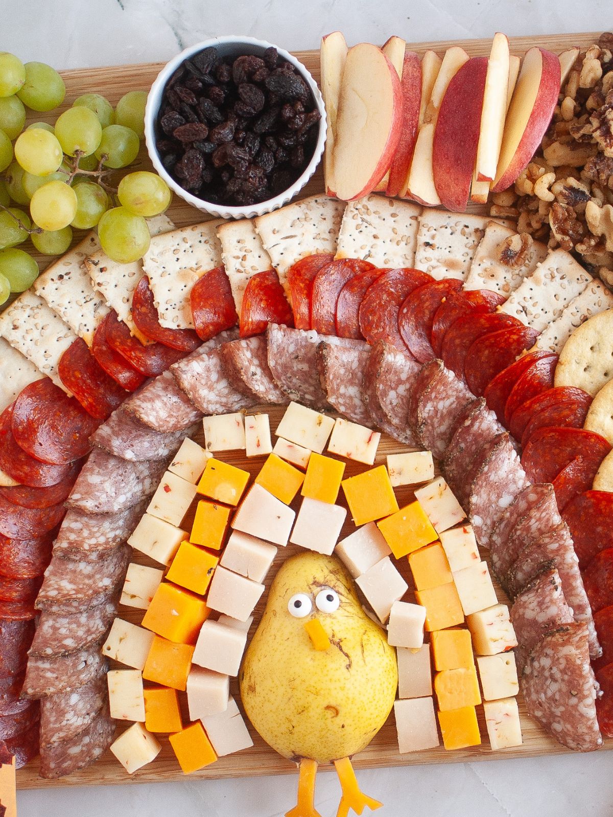Turkey made out of fruit, cheeses, meats, and crackers.
