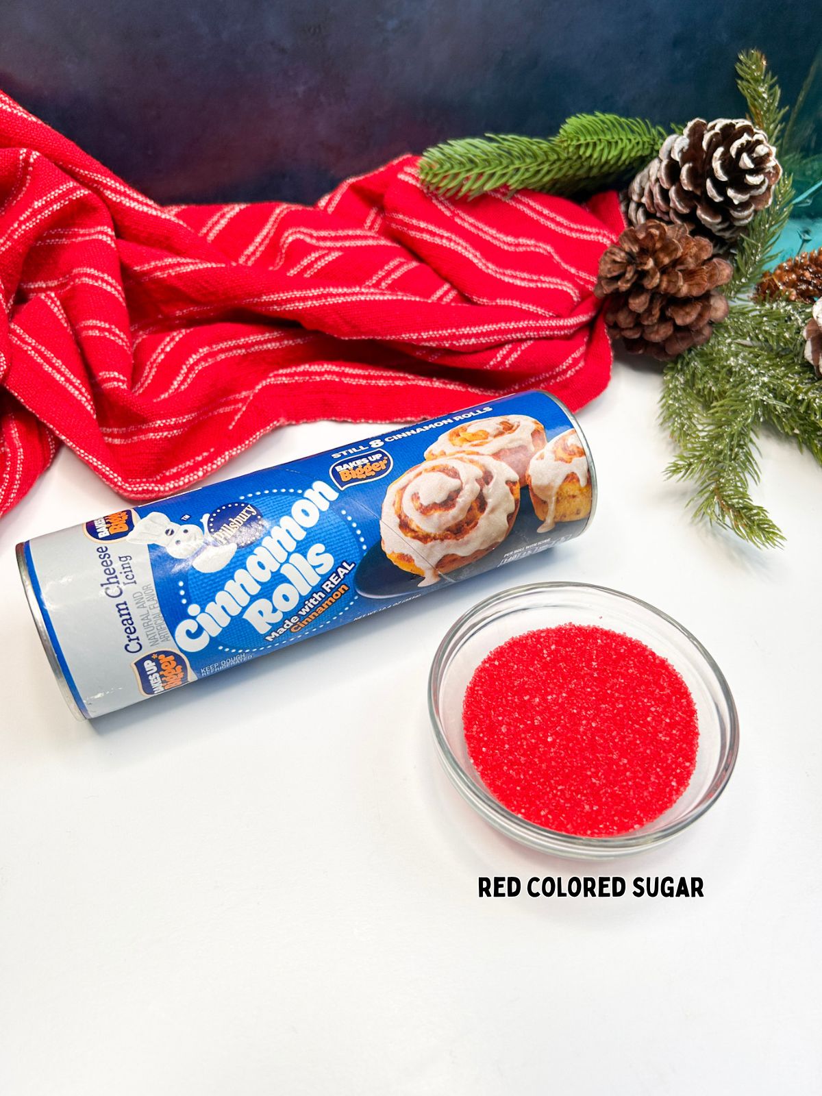 Ingredients for Candy Cane Cinnamon Rolls with red colored sugar in bowl.