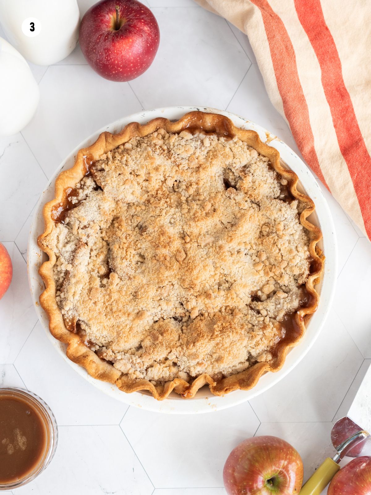 overhead view of baked apple pie with crumb topping.