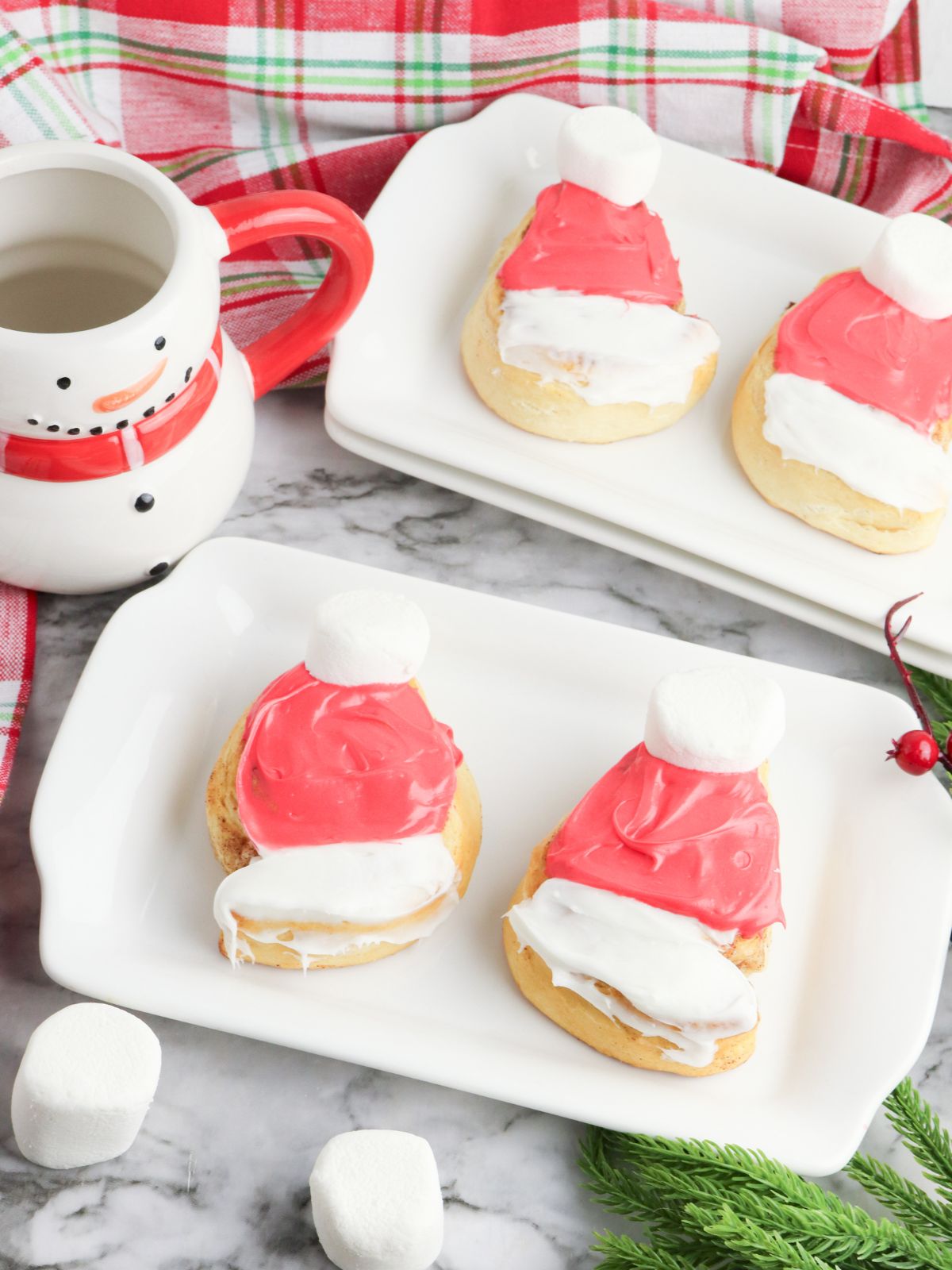 Two rectangle platters with 2 Santa Hat Cinnamon Rolls on each.