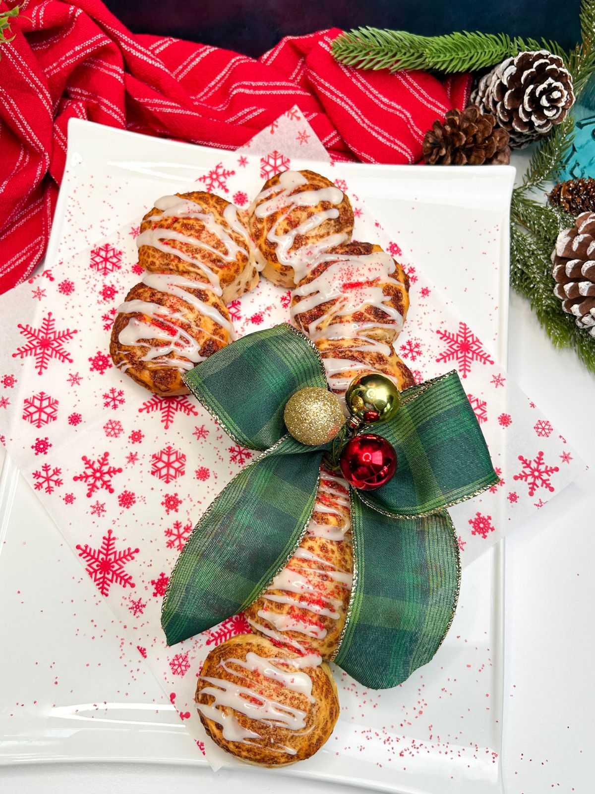 decorated edible candy cane made from cinnamon rolls.