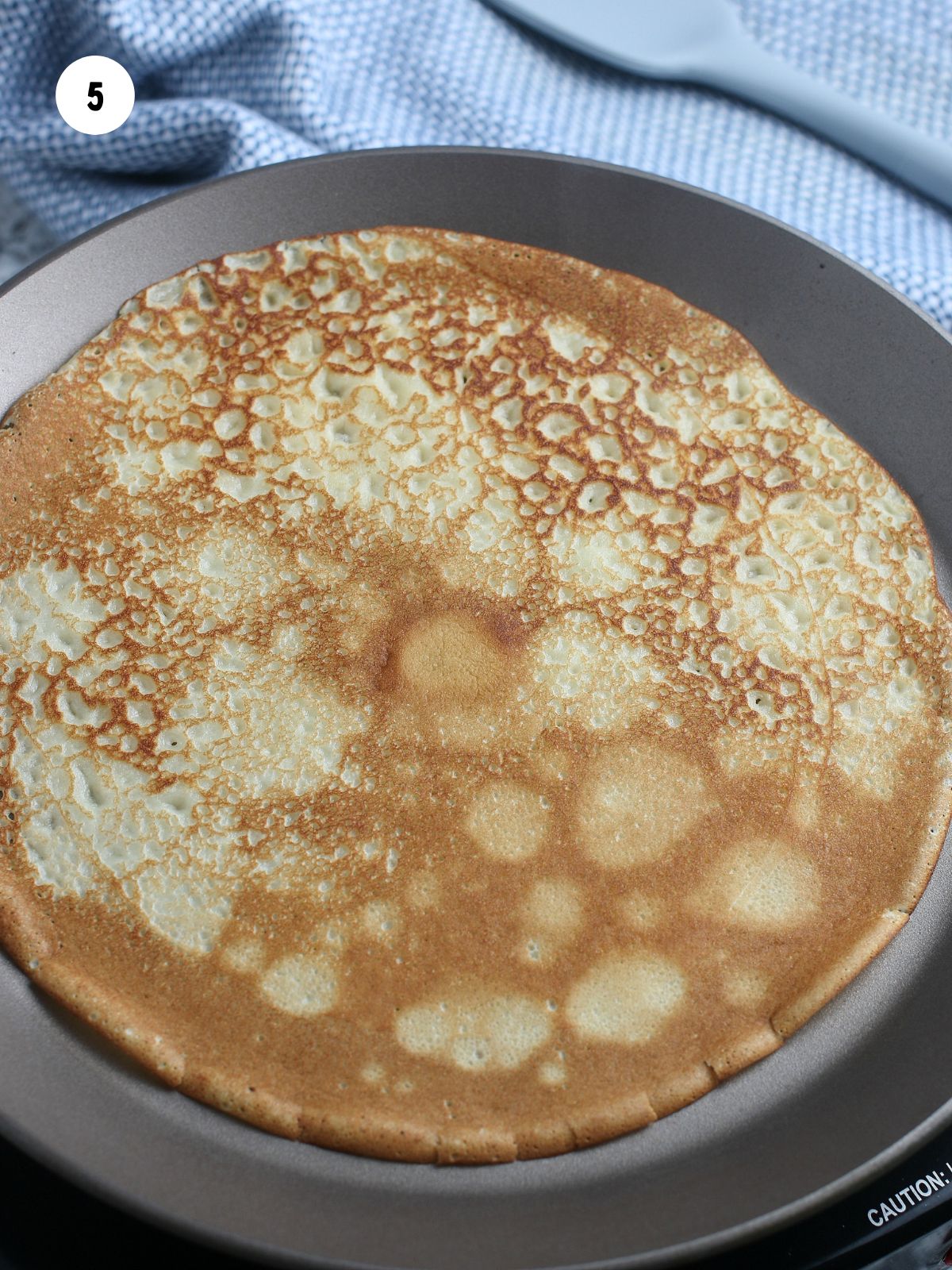 Browned crepe in pan.