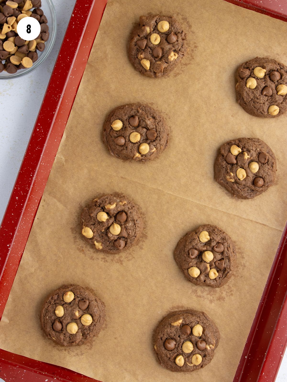 Red baking pan filled with baked chocolate cookies.