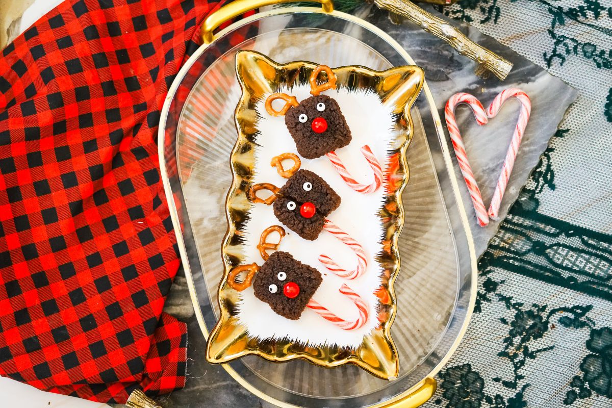 Candy Cane Reindeer Brownie Pops displayed on a gold rectangle platter.