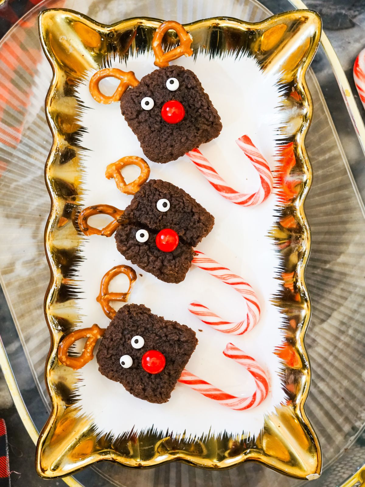 Three reindeer pops on candy canes.