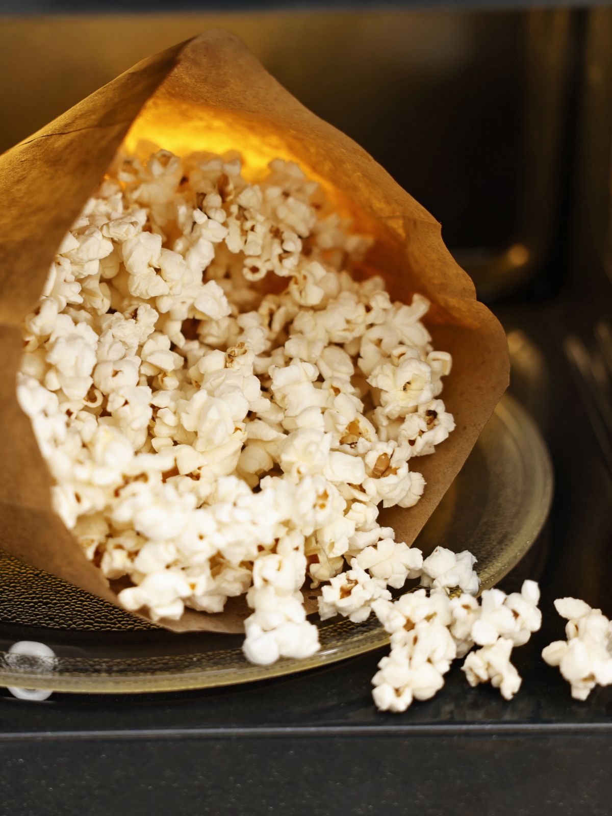 popcorn in paper bag inside microwave.