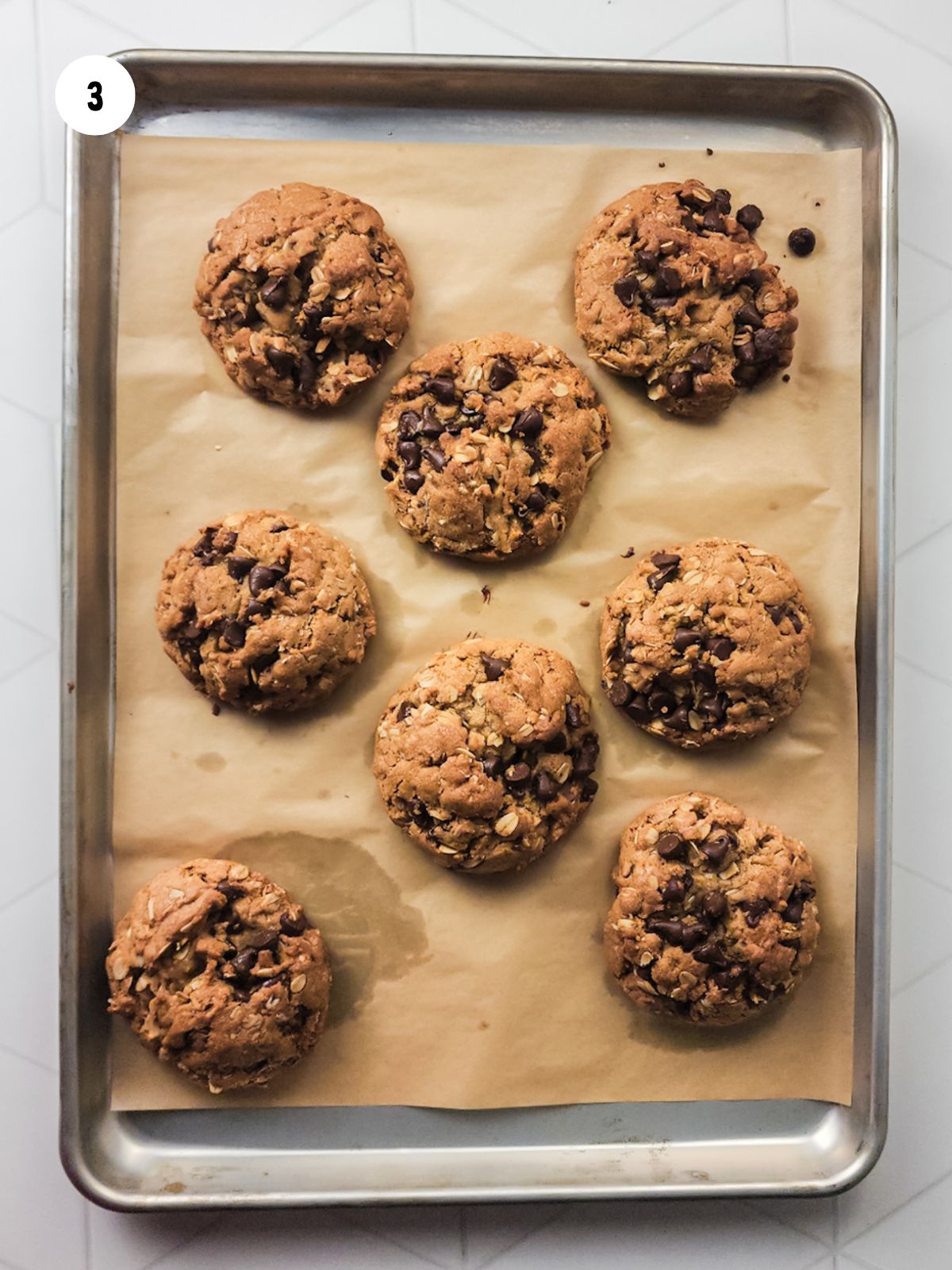 baked cookies on baking tray lined with parchment paper.