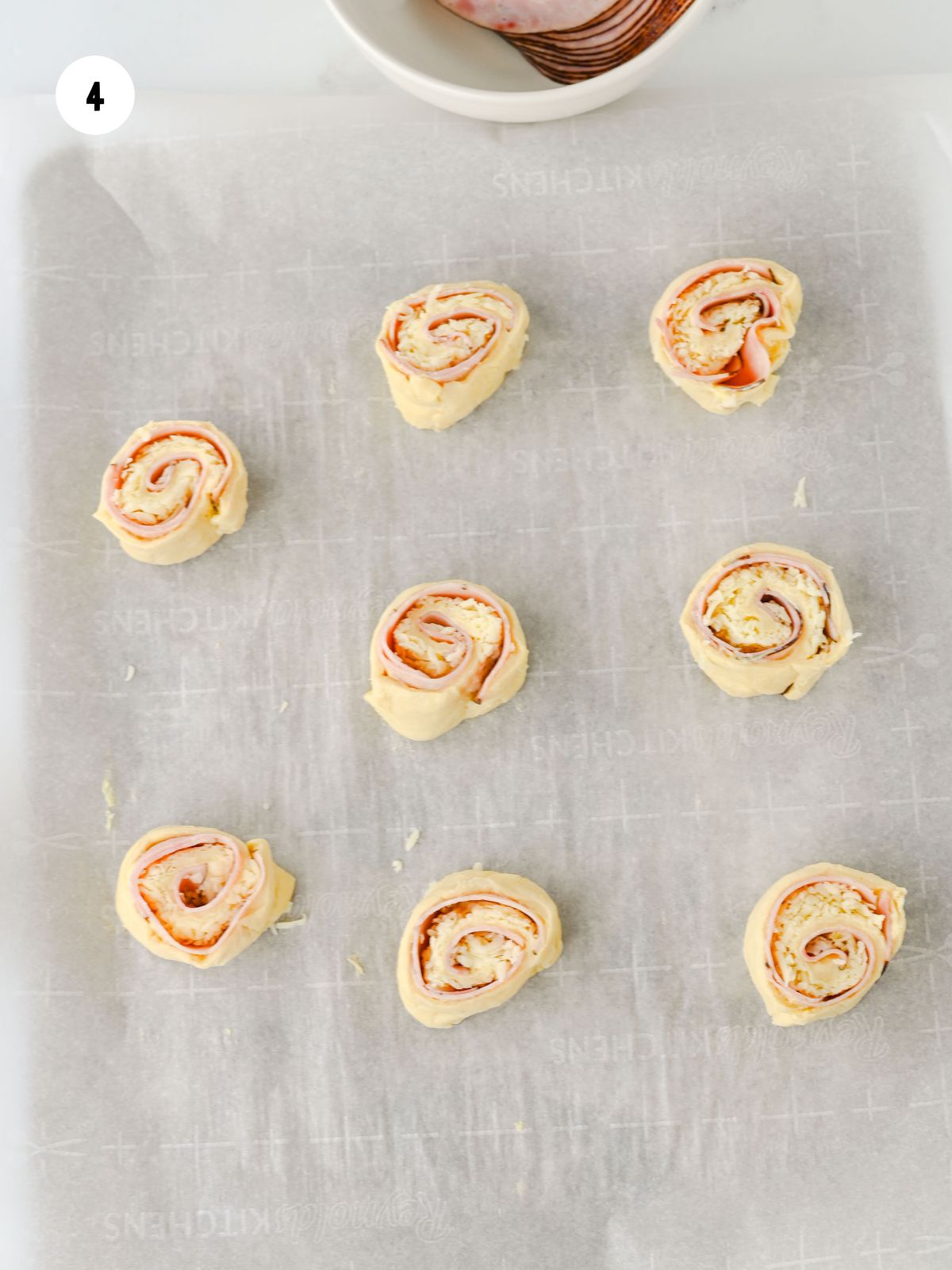 Pinwheels placed on a baking sheet.