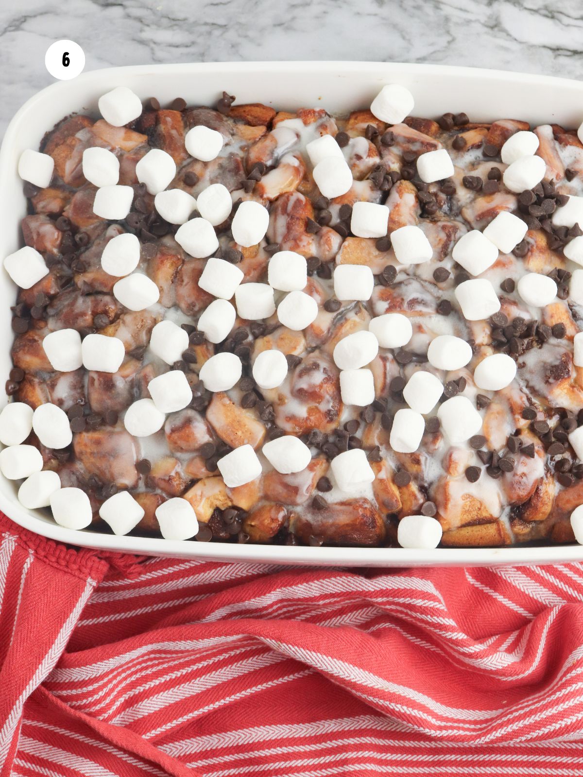hot chocolate French toast casserole baked with mini marshmallows and mini chocolate chips.