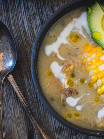 Colombian chicken and potato soup in a bowl with chunks of chicken, potatoes, corn, and broth.