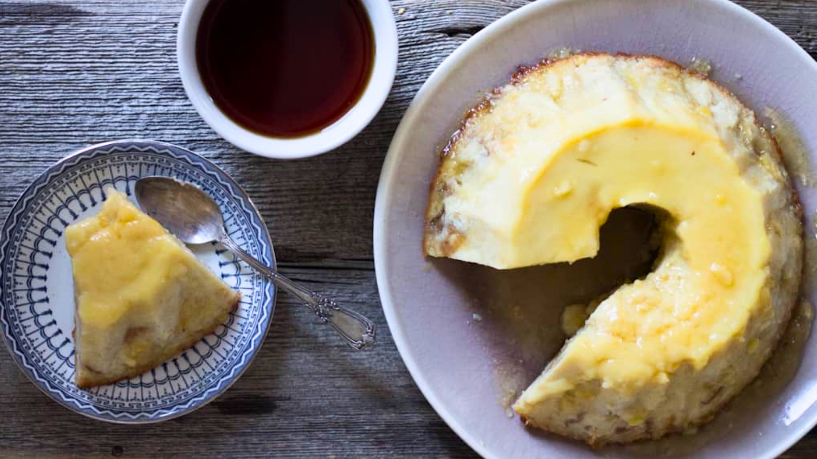 An Argentinian flan in caramel sauce on a white plate.