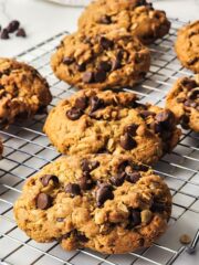 cookies with oatmeal and chocolate chips on cooling rack.