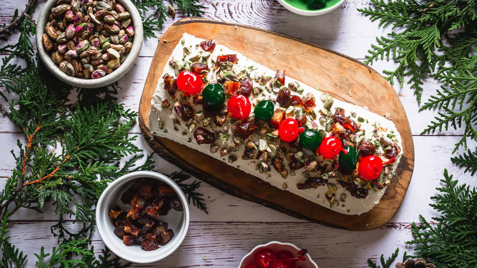 A christmas tree shaped cake on a wooden board.