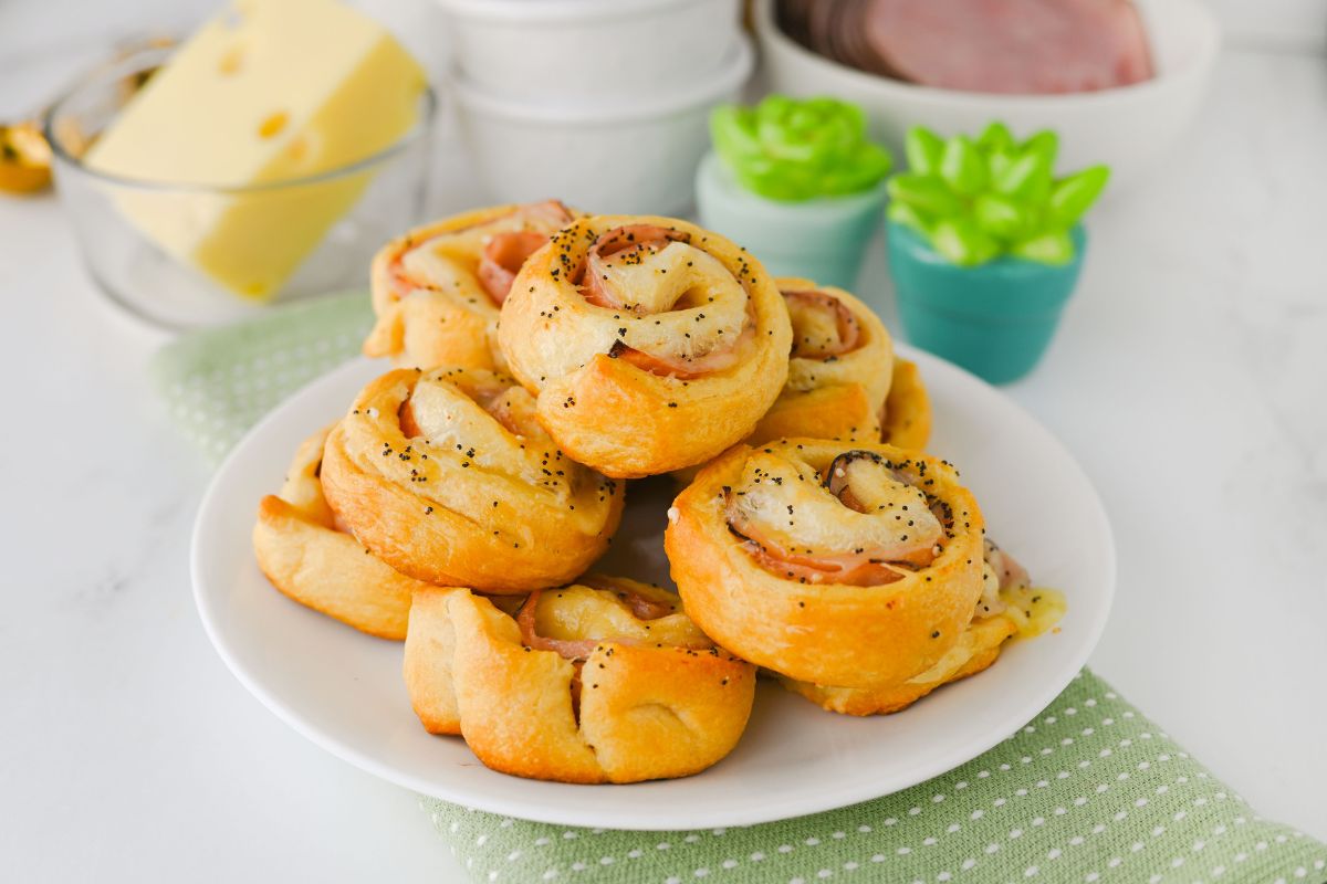 Ham and Cheese Crescent Roll Pinwheels served on a white platter.