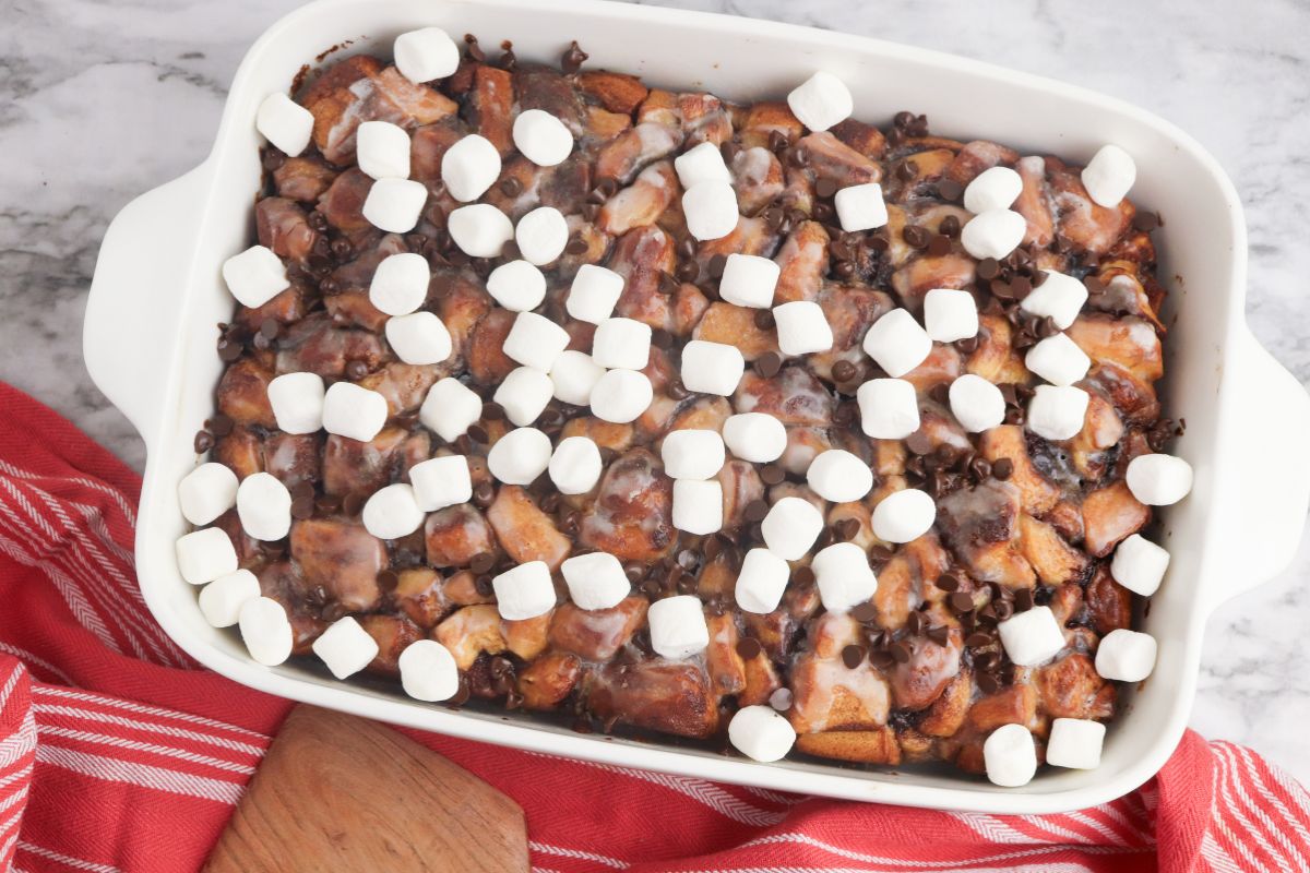 baked cinnamon roll casserole with hot cocoa and marshmallows.