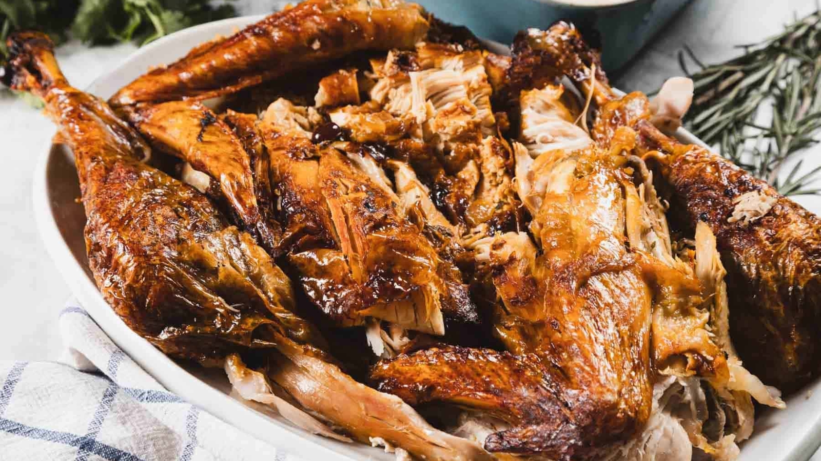 A platter filled with pieces of roasted turkey, showing crispy golden-brown skin and juicy meat.