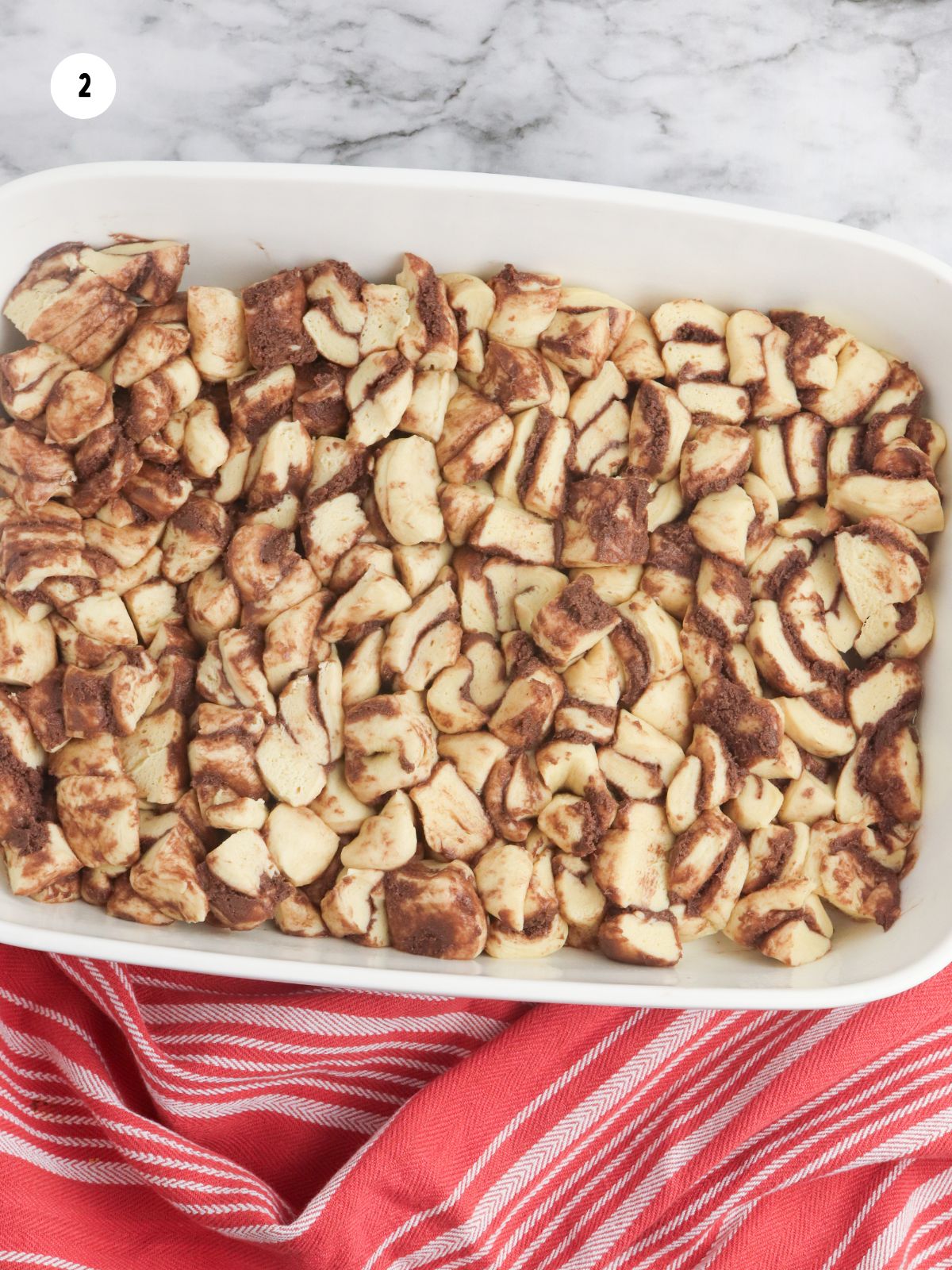 cut up cinnamon rolls in casserole dish.