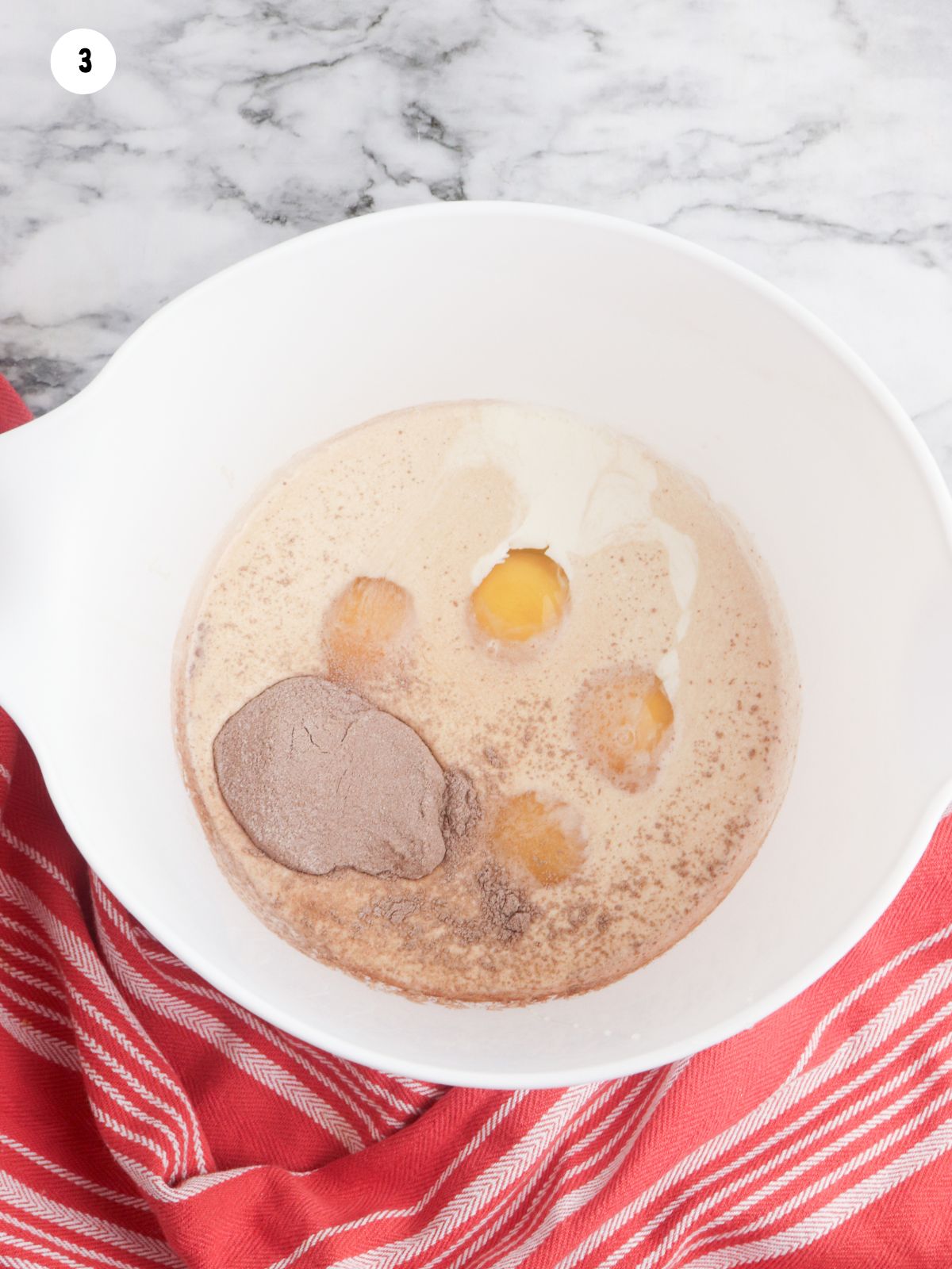 wet ingredients in bowl with packet of hot chocolate mix.