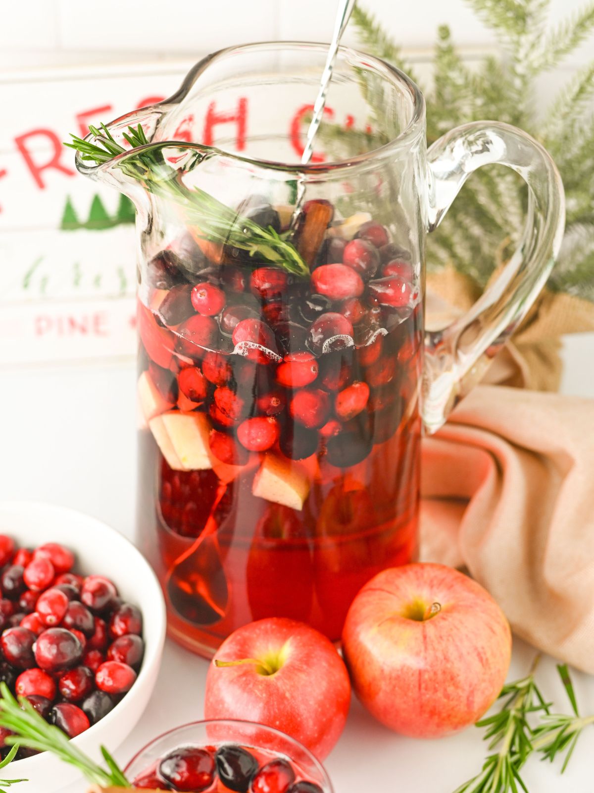 Glass pitcher of Cranberry Apple Punch.