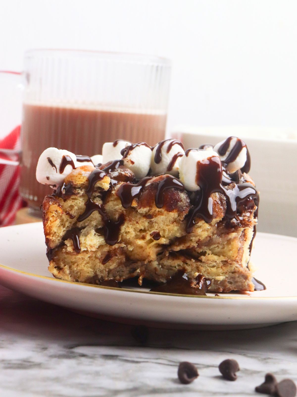 closeup of French toast casserole with Pillsbury hot cocoa cinnamon rolls topped with mini marshmallows on plate.
