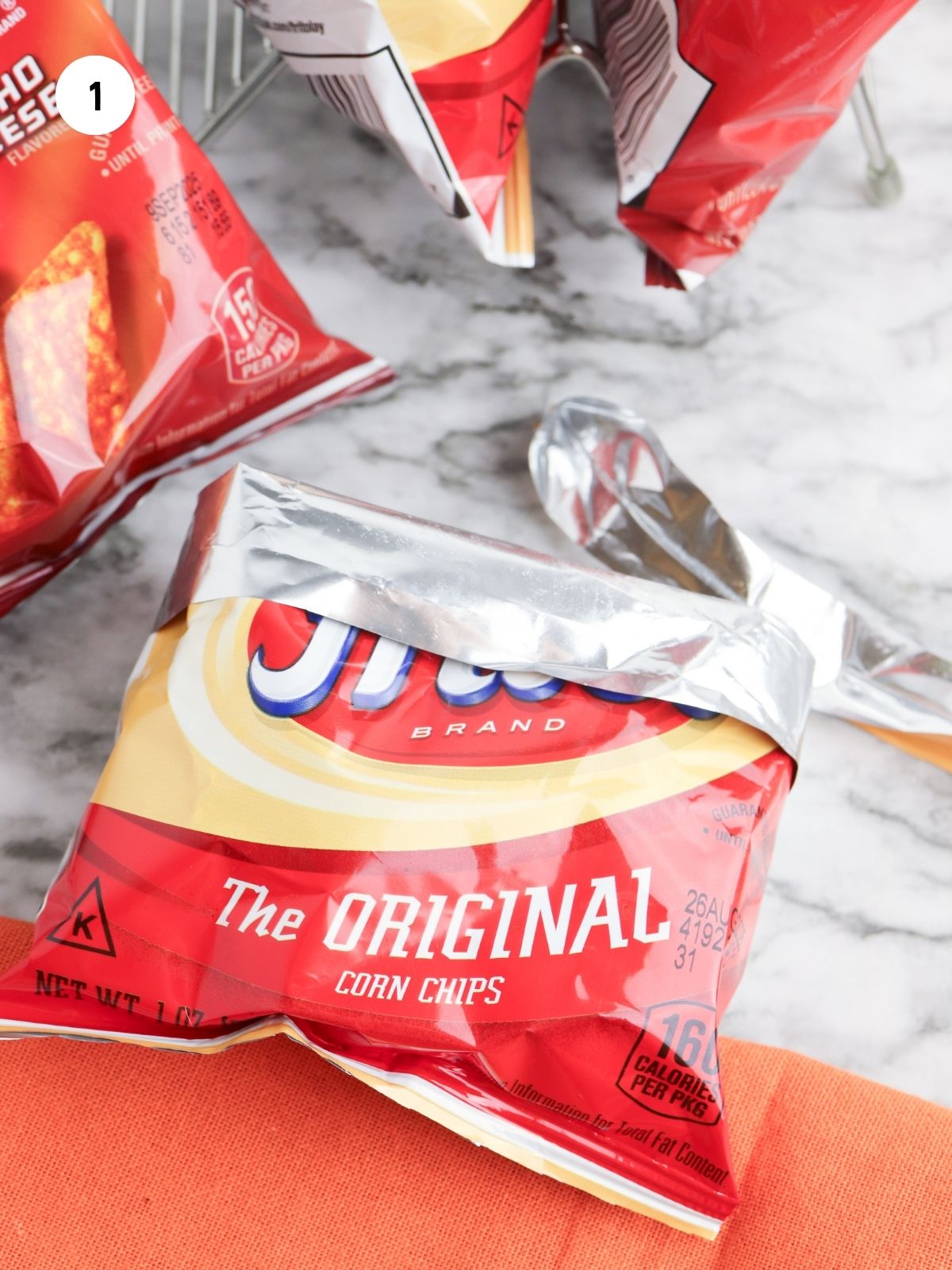 Prepare the bag by cutting off the top then folding the top edges down.